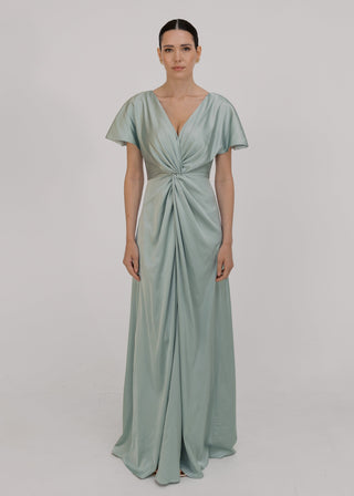 Woman wearing a green bridesmaid dress with twist detail at front by TH&TH.