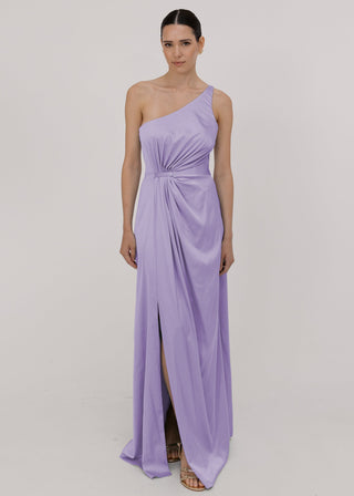 Model wearing a floor length lilac satin bridesmaid dress with one shoulder and slit in skirt by TH&TH Bridesmaids.