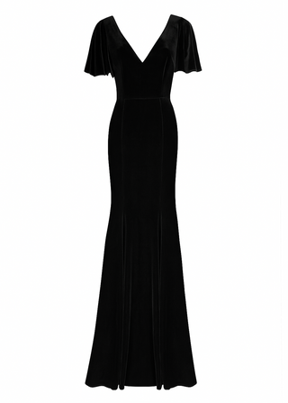 Woman wearing a long black bridesmaid dress with angel sleeves and V neck in velvet.