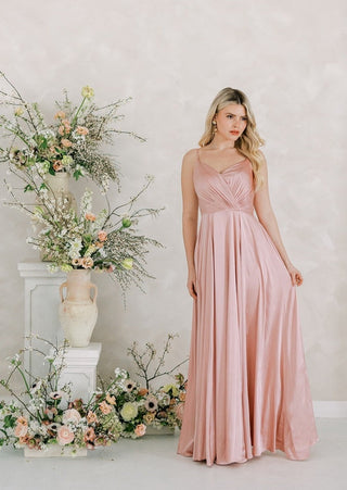 Blush satin bridesmaids maxi dress with pleated bodice and spaghetti straps and full skirt by TH&TH bridesmaids