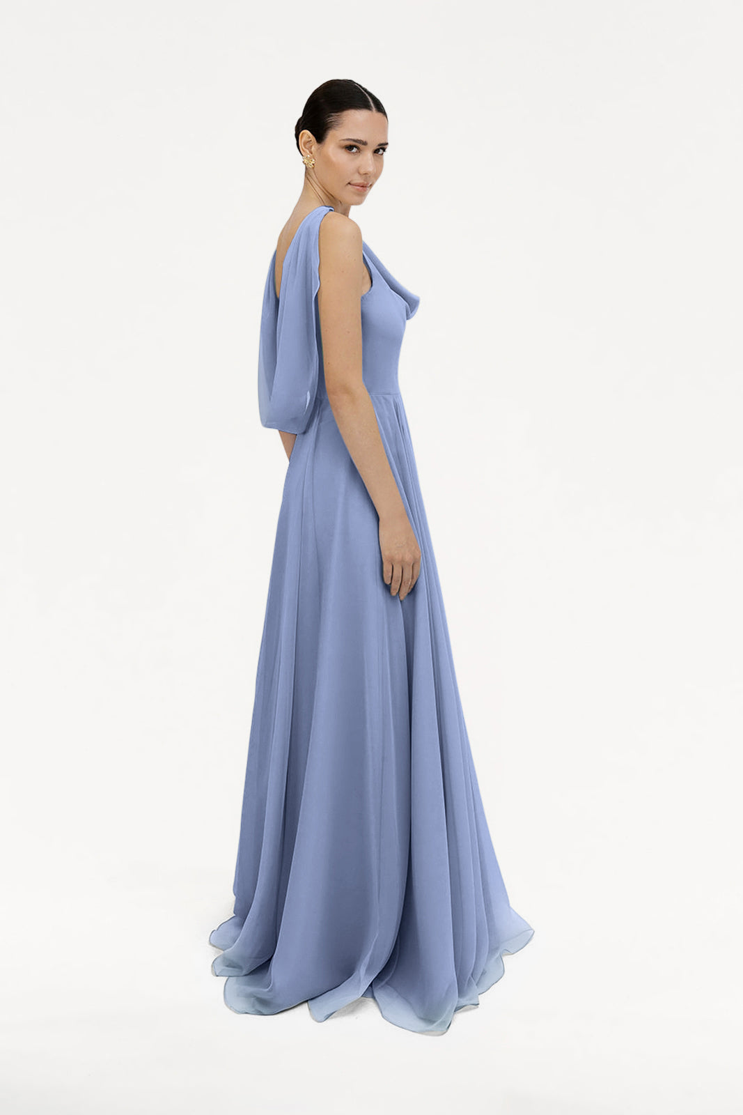 A woman in profile wears the TH&TH Athena Bridesmaid Dress in French Blue chiffon, featuring a draped sleeve and fitted bodice, set against a plain white background.