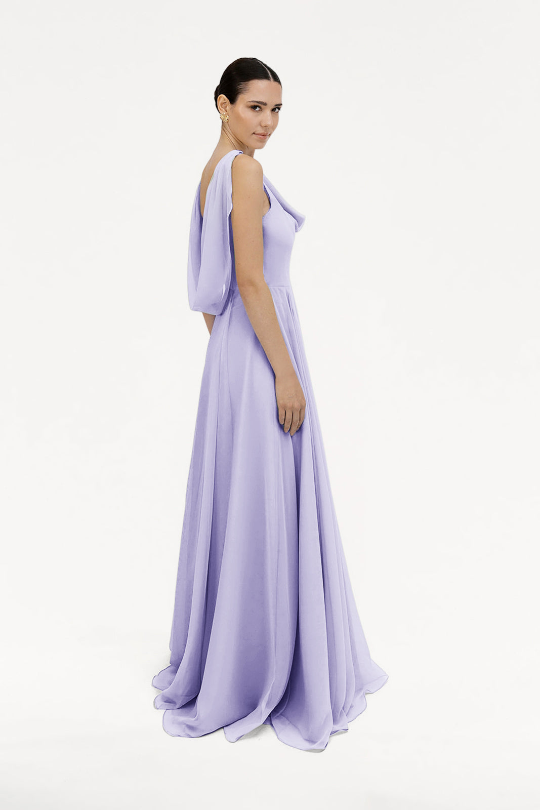 A woman poses against a white background in the TH&TH Athena Bridesmaid Dress, featuring lilac mist chiffon and draped sleeves.