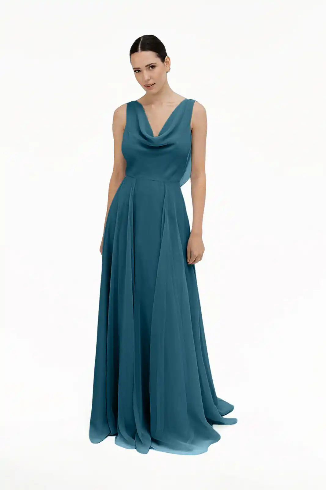 A woman poses against a white background wearing the TH&TH Athena Bridesmaid Dress in Emerald Dawn—a sleeveless, floor-length chiffon gown with a draped cowl neckline and pleated skirt.