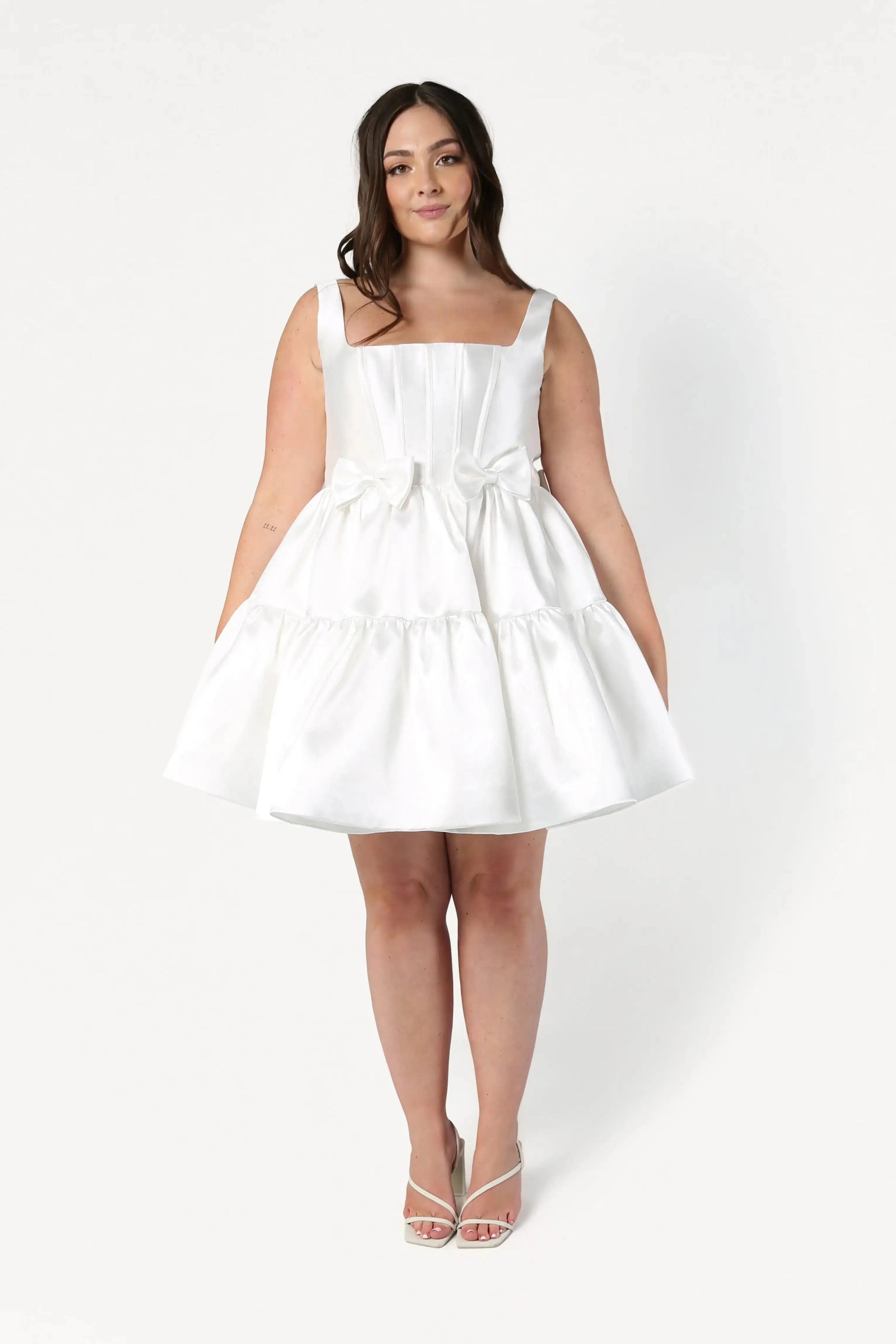 Woman wearing a white dress on a white background