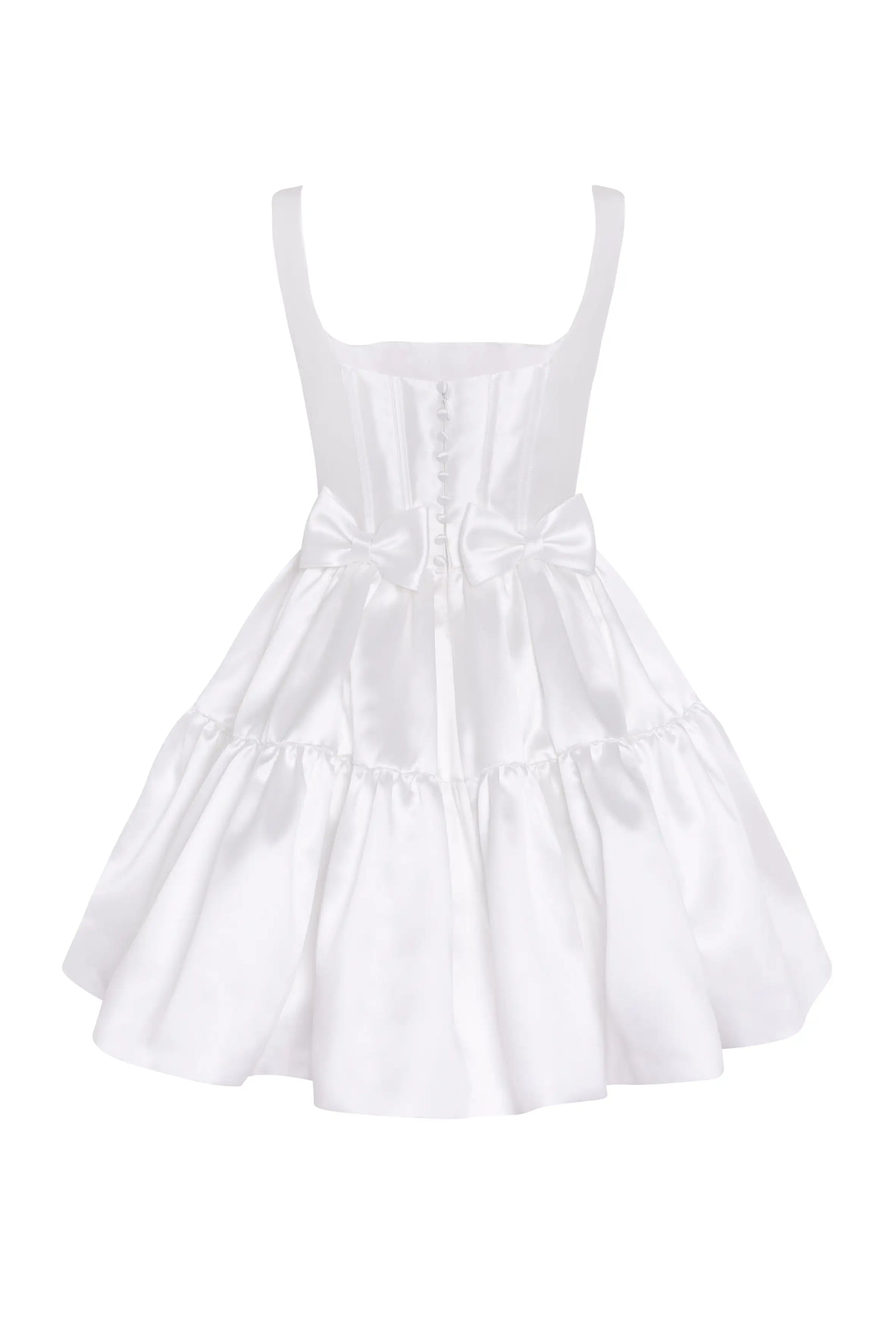 The Bloom Bridal Mini Dress in Ivory by TH&TH is a sleeveless satin twill mini with a corseted bodice, square neckline, button accents, waist bow, and a flared ruffled skirt.