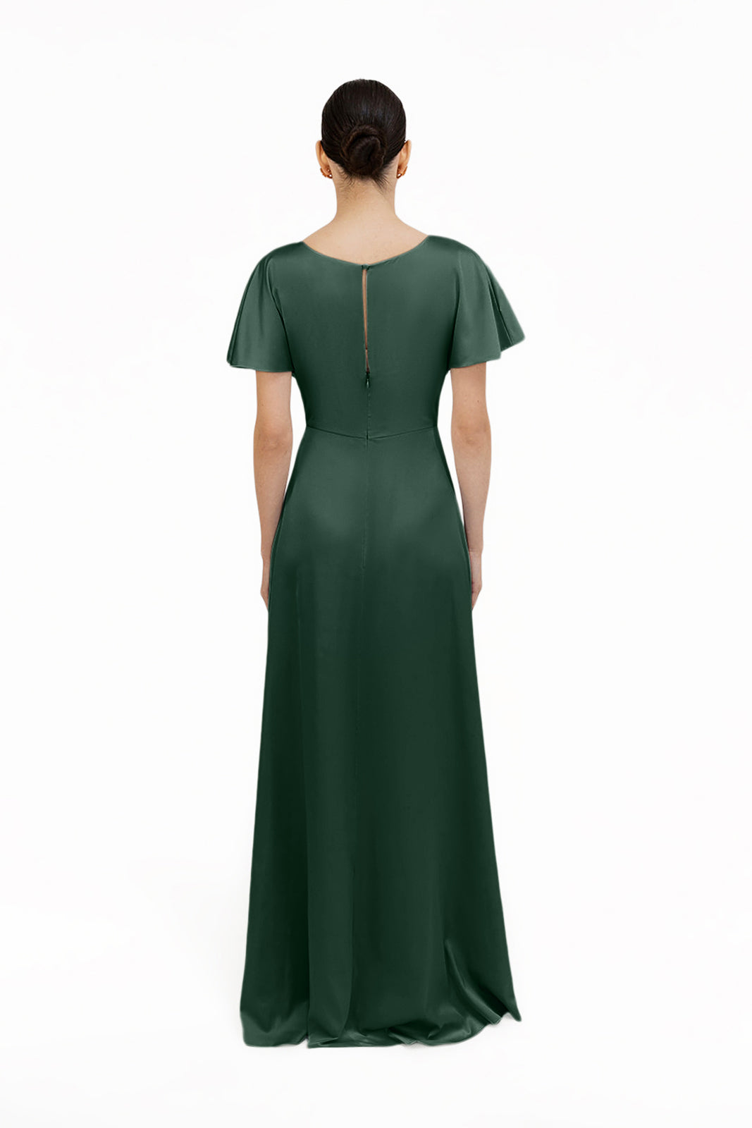 A woman faces away, wearing the TH&TH Camilla Bridesmaid Dress in Olive Grove Satin—a floor-length gown with short sleeves and a fitted waist. Her dark hair is tied back against a plain white background.