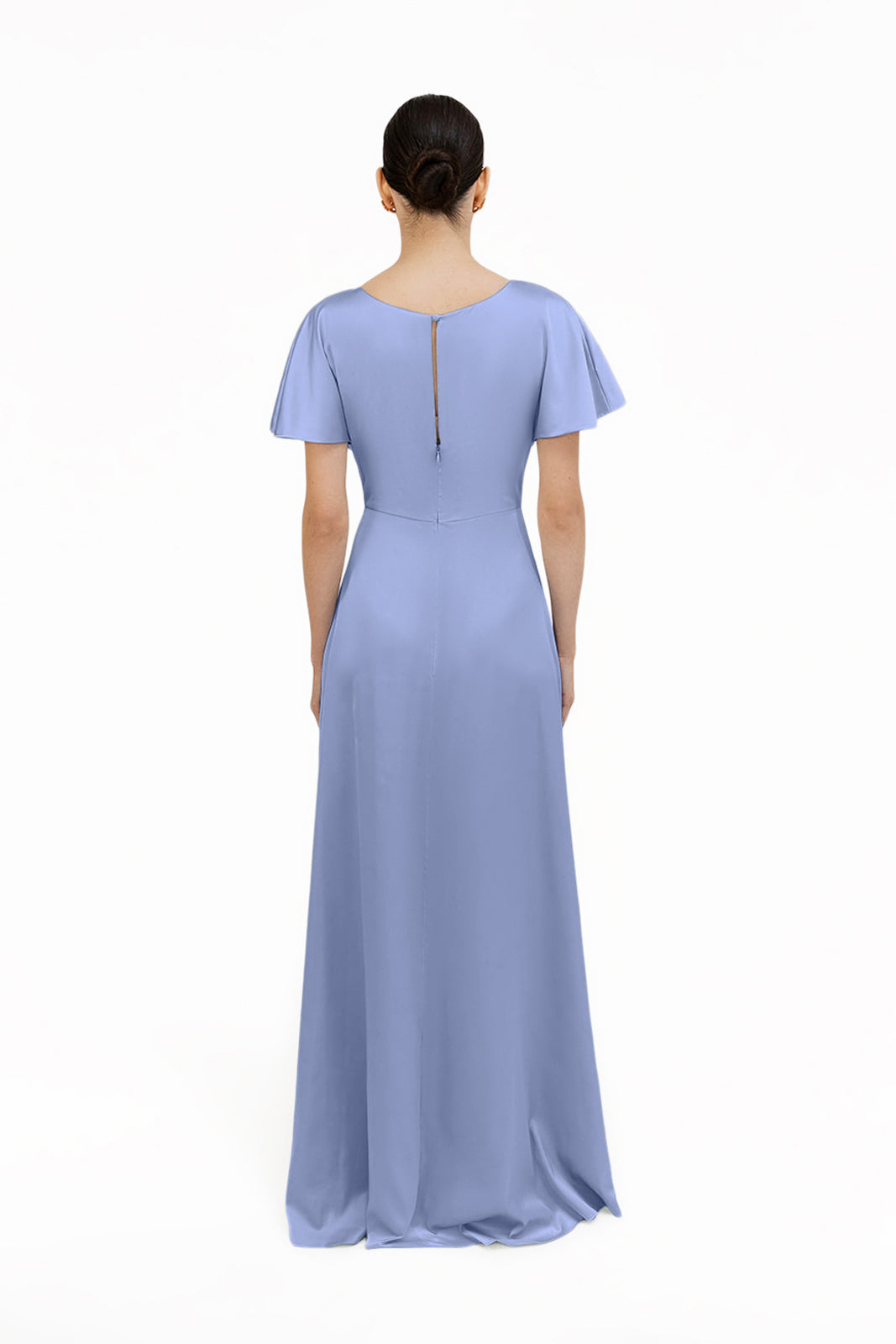 A woman faces away, wearing the TH&TH Camilla Bridesmaid Dress in French Blue Satin. This floor-length gown features short flutter sleeves, a high waistline, back zipper, and a smooth flowing skirt against a plain white background.