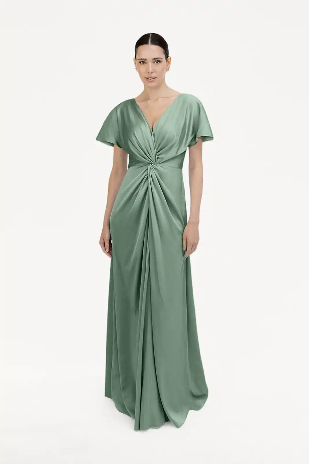 A woman wears the TH&TH Camilla Bridesmaid Dress in sage green satin, featuring a floor-length silhouette, V-neckline, short sleeves, and gathered waist detail. The background is plain white.