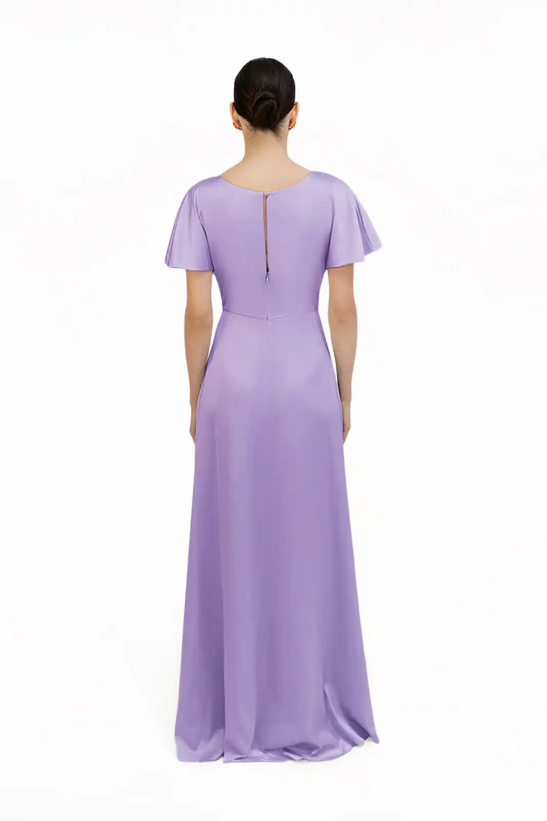 A woman faces away, wearing the TH&TH Camilla Bridesmaid Dress in Violet Satin—a floor-length, short-sleeved gown with a fitted waist and back zipper—shown in a size-inclusive range against a plain white background.