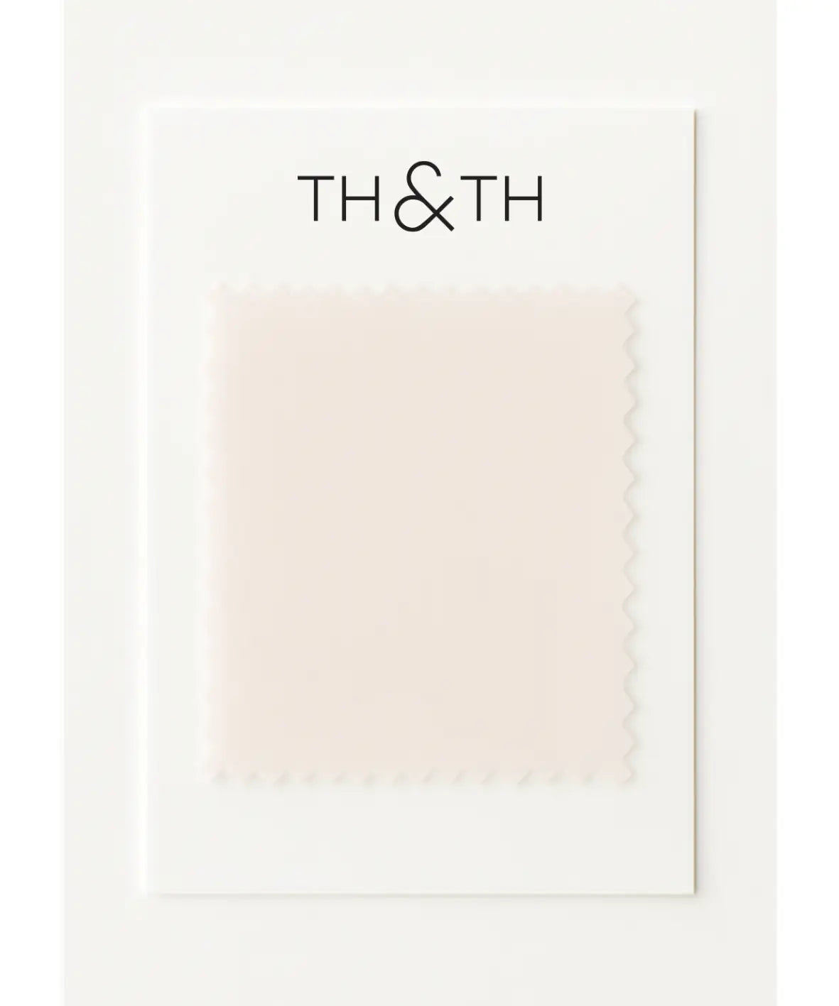 A Chiffon Swatch by TH & TH features a square of pale pink chiffon fabric with zigzag edges on a white card—ideal for visualizing an elegant drape in your next chiffon bridesmaid dress.