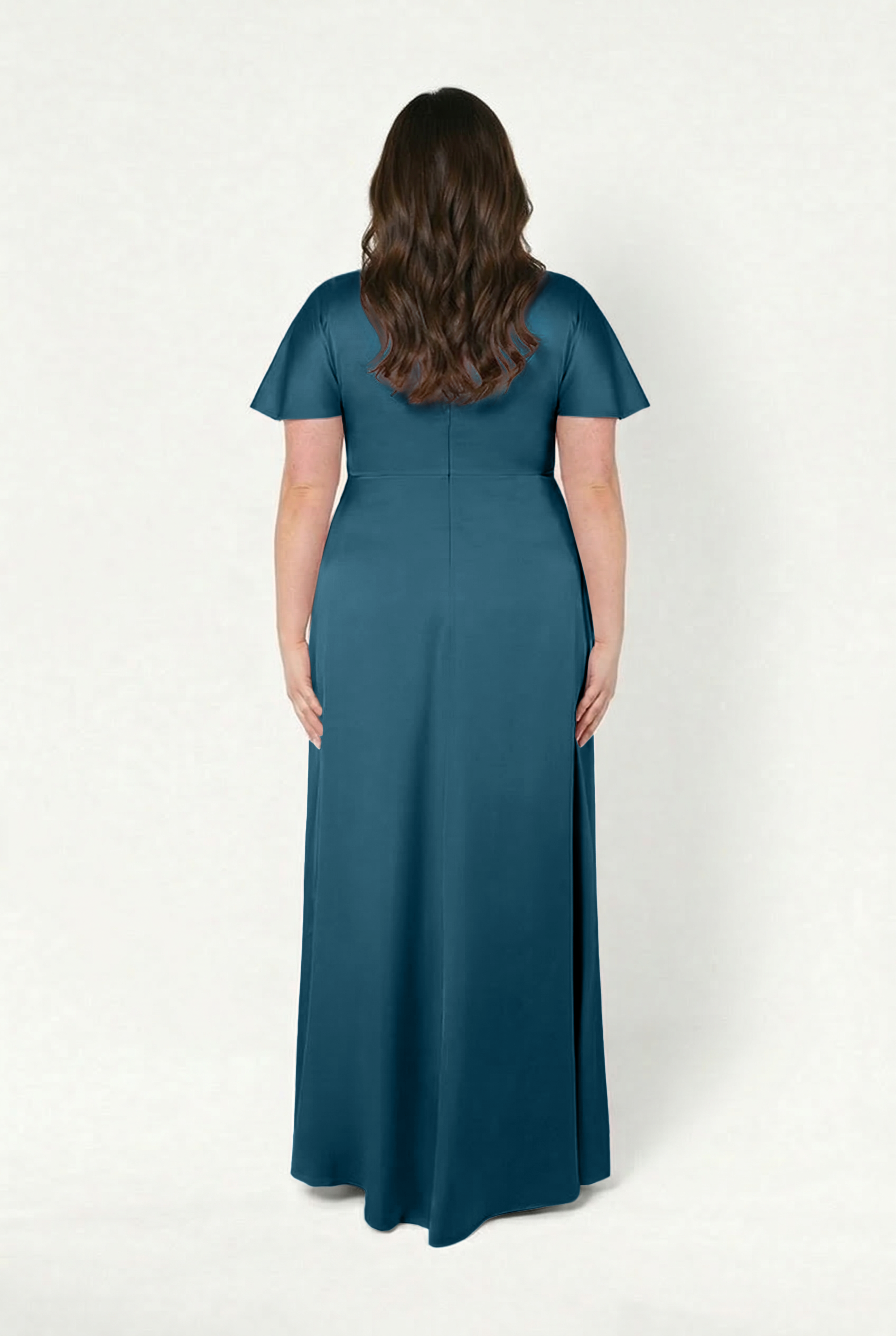 Back view of a size-inclusive bridesmaid wearing the TH&TH Camilla Bridesmaid Dress in Emerald Dawn Satin, featuring short flutter sleeves and a fitted waist, shown against a white background.
