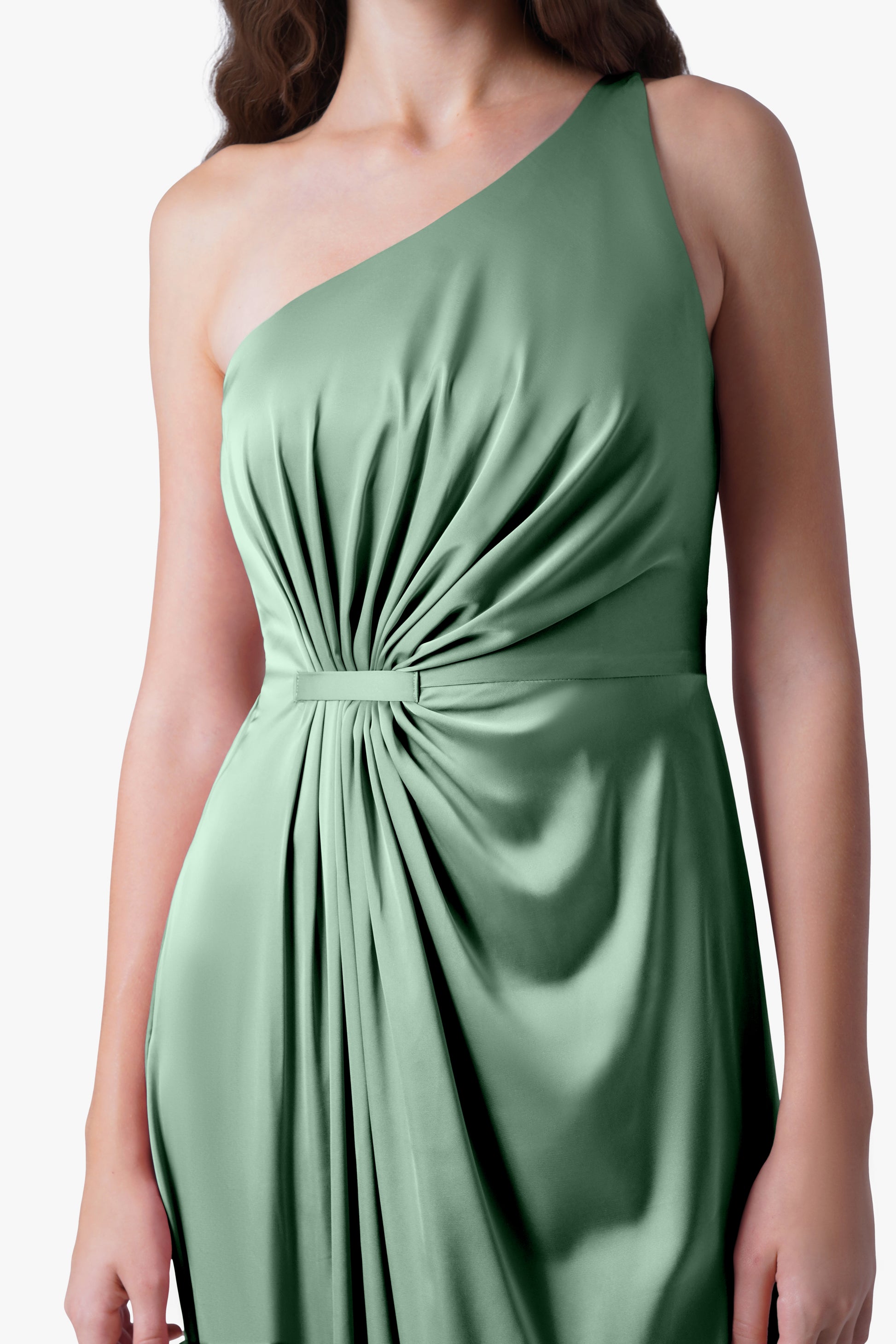 A woman models the TH&TH Greta Bridesmaid Dress in sage green satin—a sleeveless, one-shoulder gown with Grecian draping, gathered details, and a fitted waist—shown from shoulders to hips against a plain background.