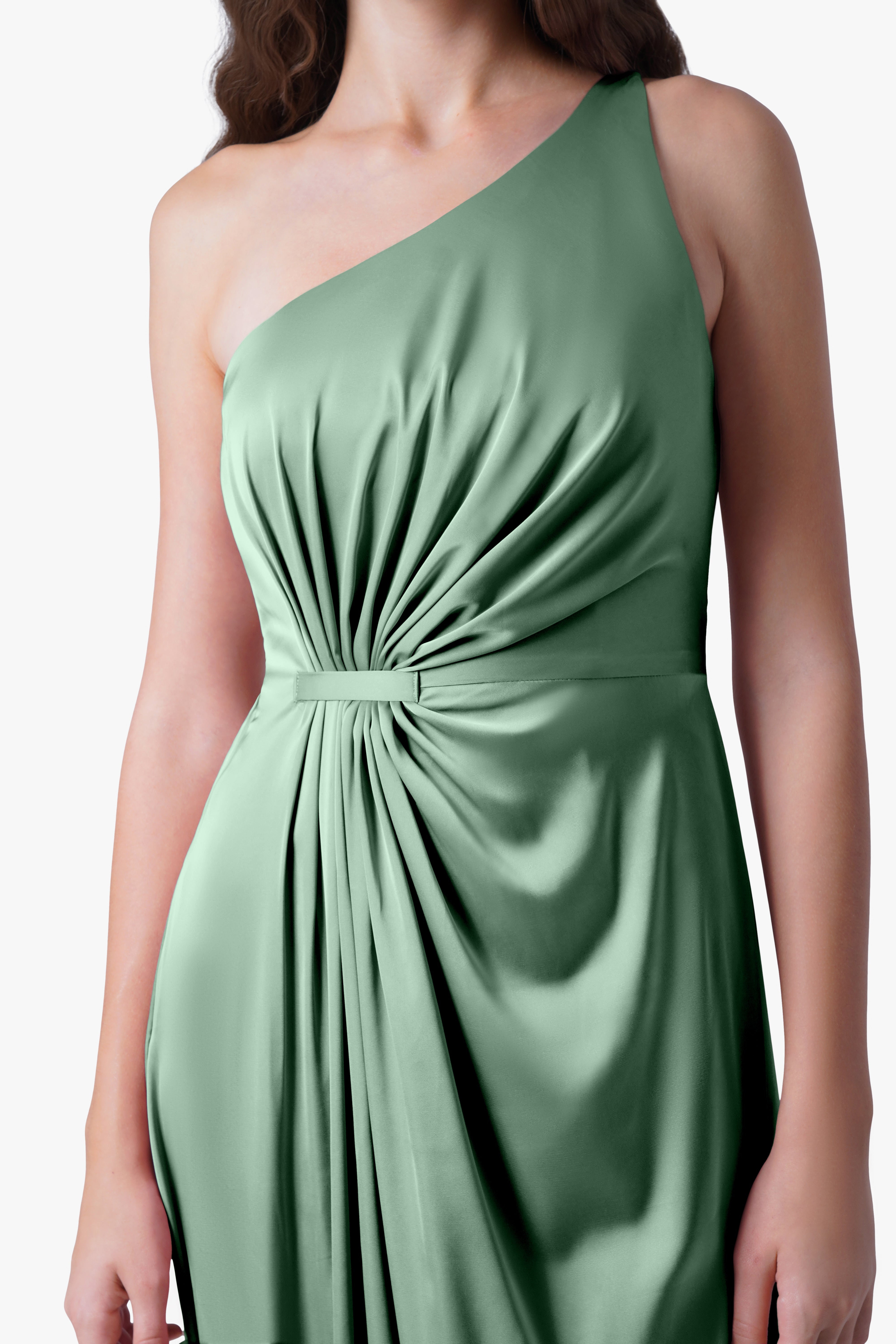 A woman models the TH&TH Greta Bridesmaid Dress in sage green satin—a sleeveless, one-shoulder gown with Grecian draping, gathered details, and a fitted waist—shown from shoulders to hips against a plain background.