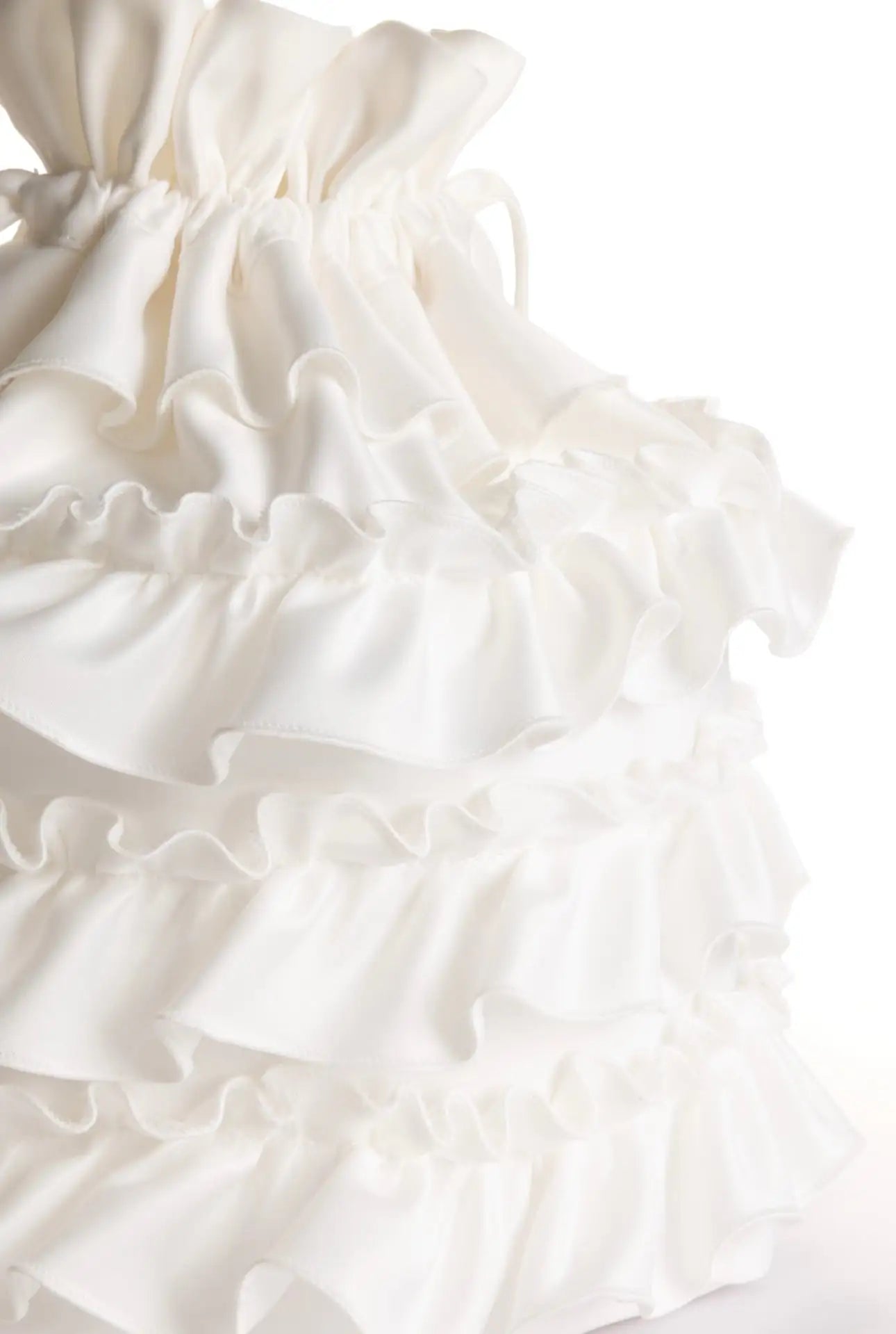 The TH&TH 'Happily Ever After' Ruffle Bridal Bag in Ivory showcases matte satin with tiered ruffles and gathered details, creating a soft, textured look—ideal as a chic accessory for hen parties or elegant bridal outfits.