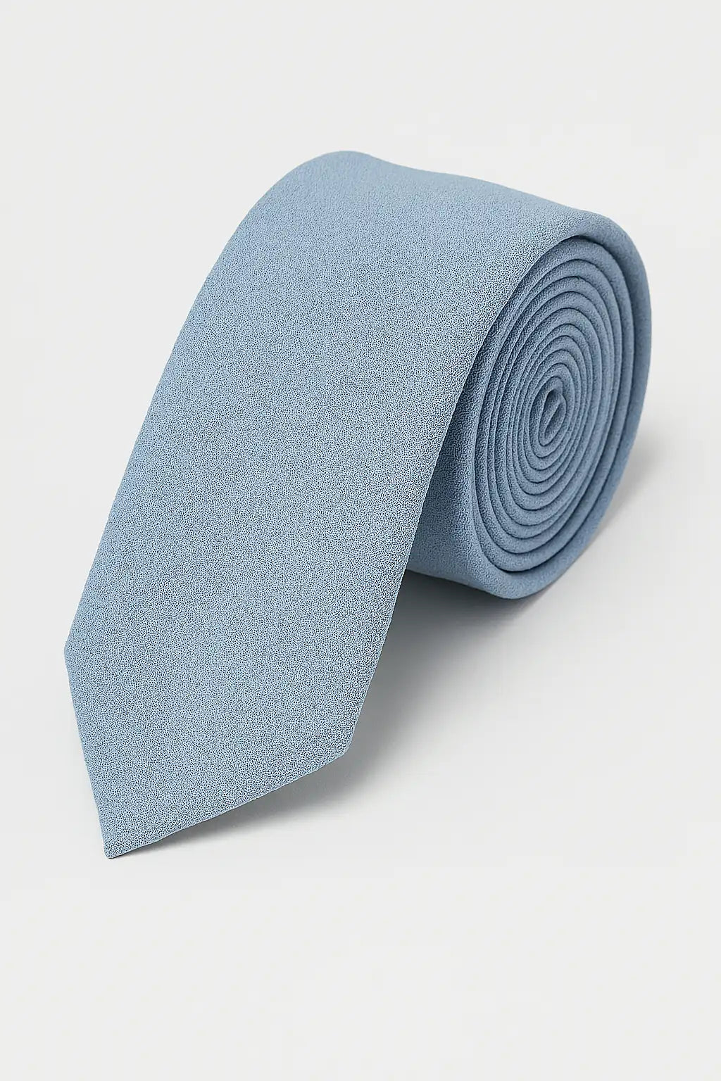 The TH&TH Moss Crepe Tie in light blue, ideal as a wedding accessory, is neatly rolled up and displayed on a plain white background.