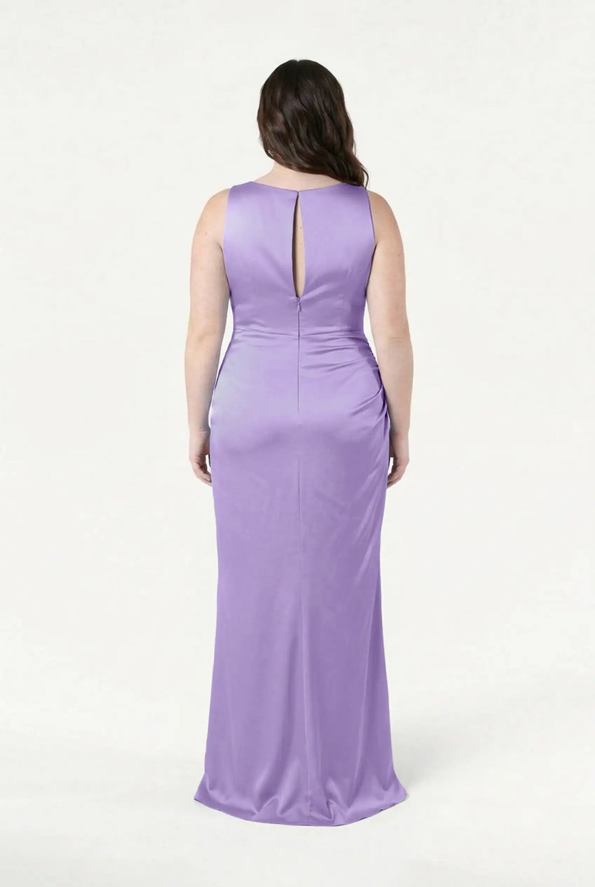 A woman faces away, wearing the TH&TH Nala Bridesmaid Dress in Violet Satin. This sleeveless, floor-length gown features a keyhole back and smooth satin texture, perfect for modern bridal parties. The background is plain white.