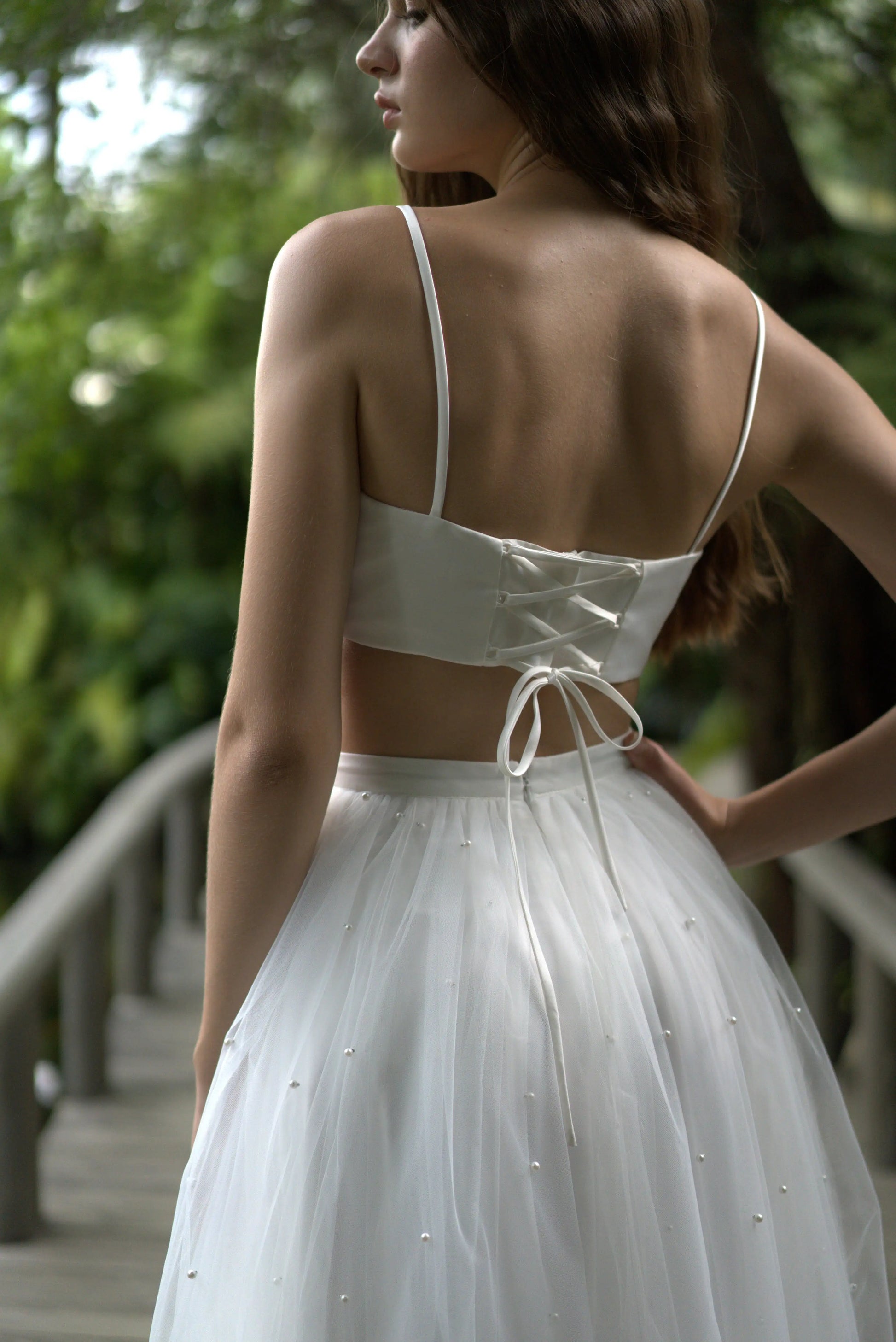woman wearing cropped lace up back top 