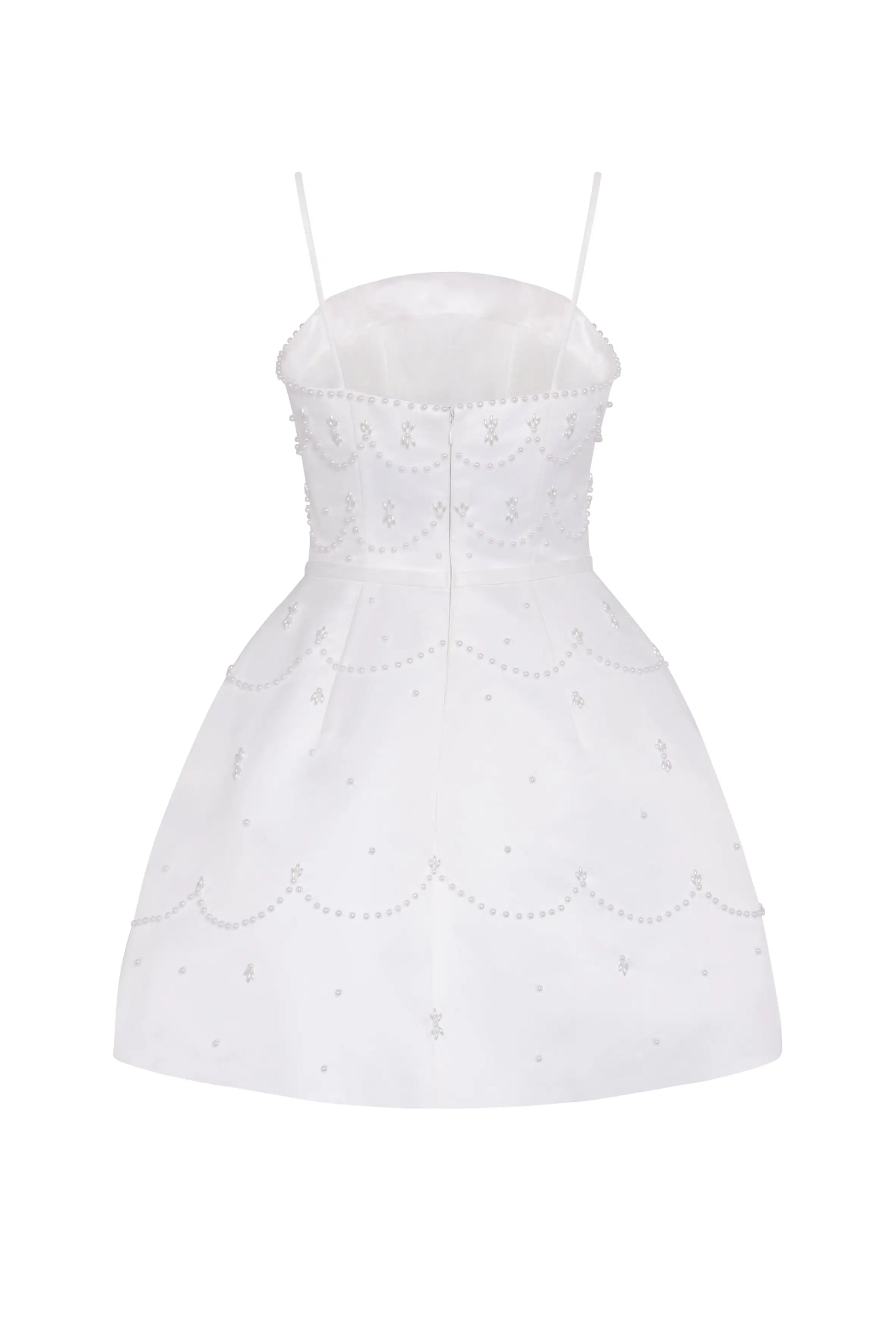 The Pearl Bridal Mini Dress in Ivory by TH&TH features a fitted bodice, thin spaghetti straps, and elegant pearl or sequin scalloped detailing. This white sleeveless mini dress flares gently at the skirt for a refined bridal look.