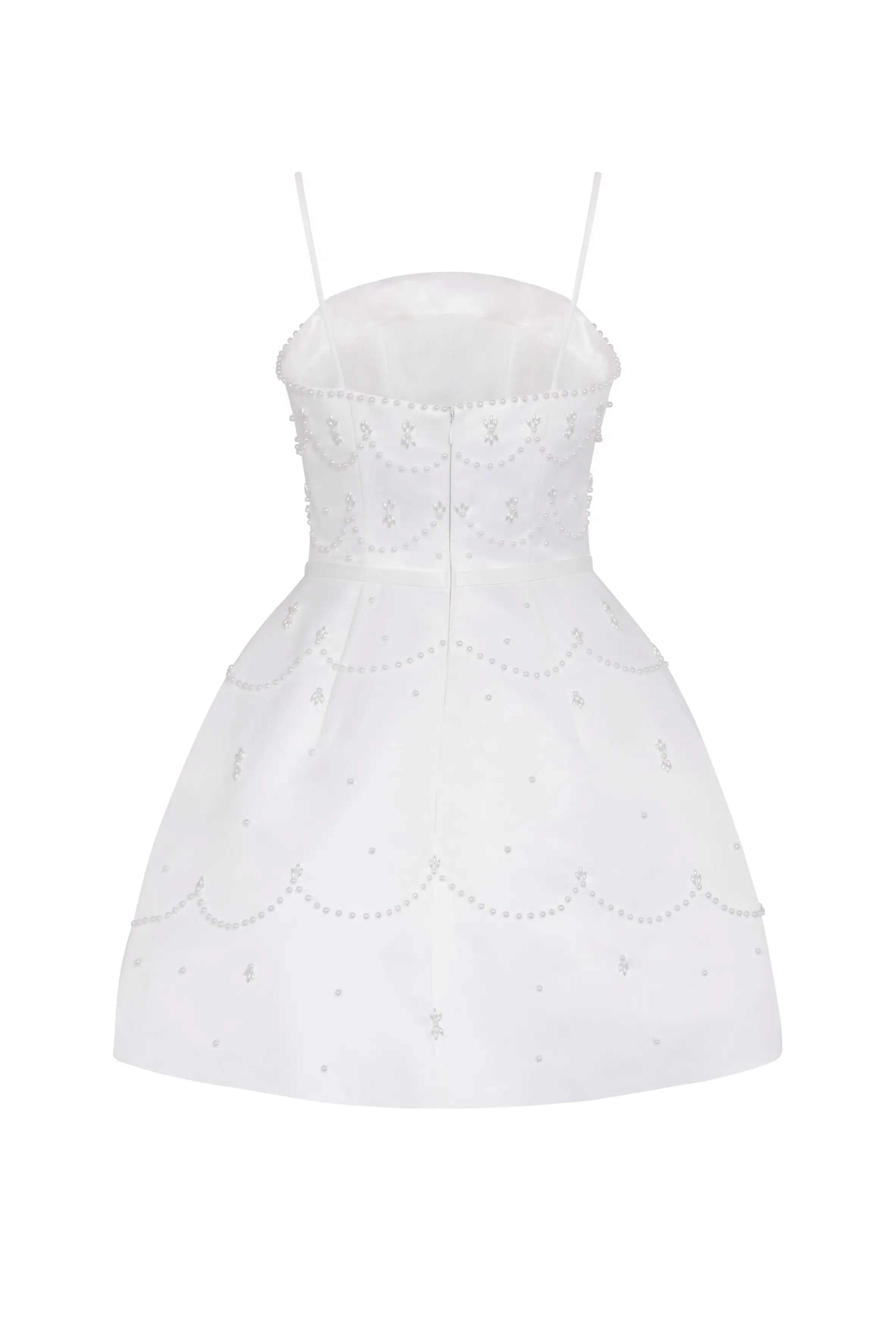 The Pearl Bridal Mini Dress in Ivory by TH&TH features a fitted bodice, thin spaghetti straps, and elegant pearl or sequin scalloped detailing. This white sleeveless mini dress flares gently at the skirt for a refined bridal look.