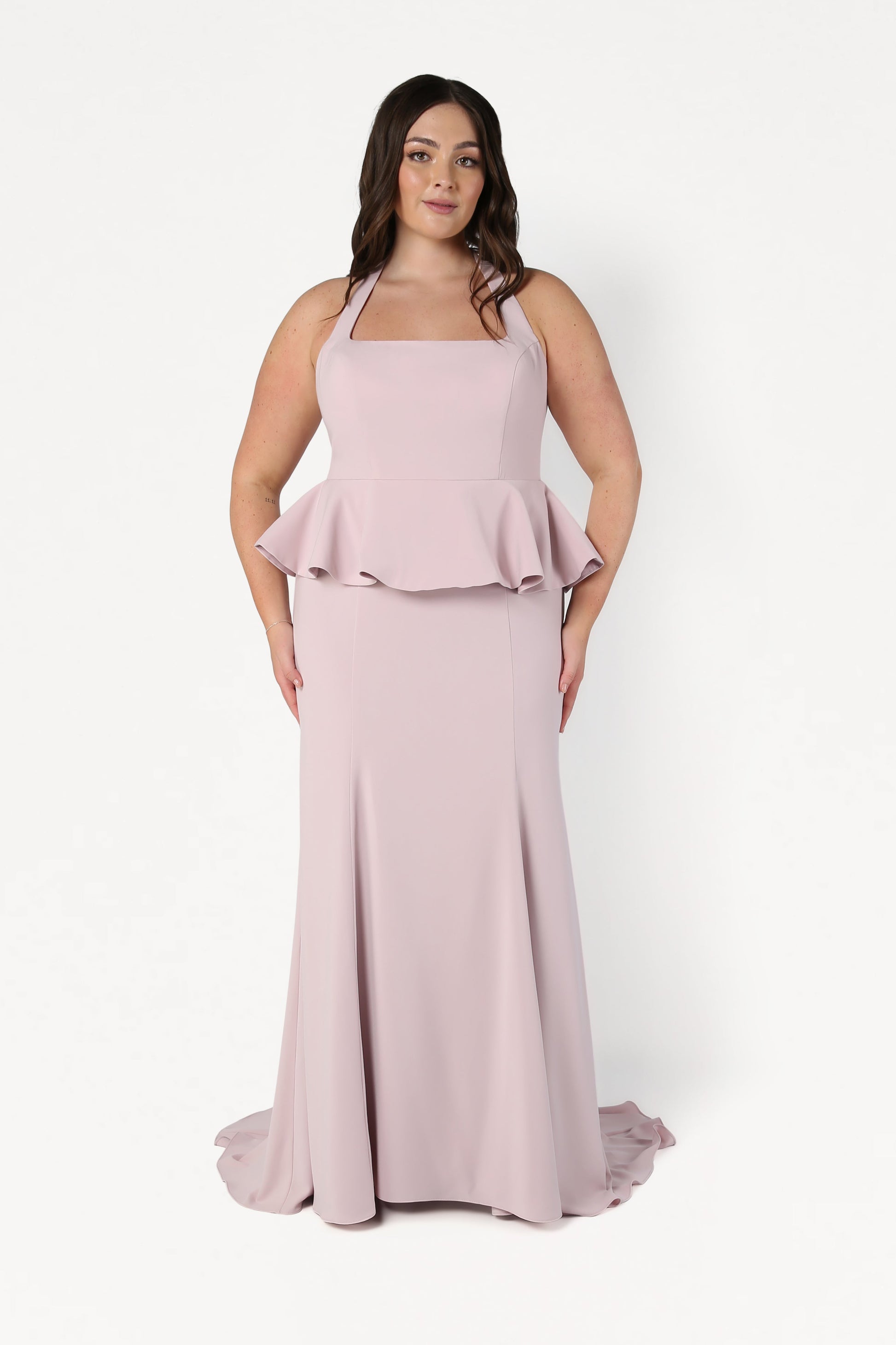 Woman wearing a pink evening gown with a white background