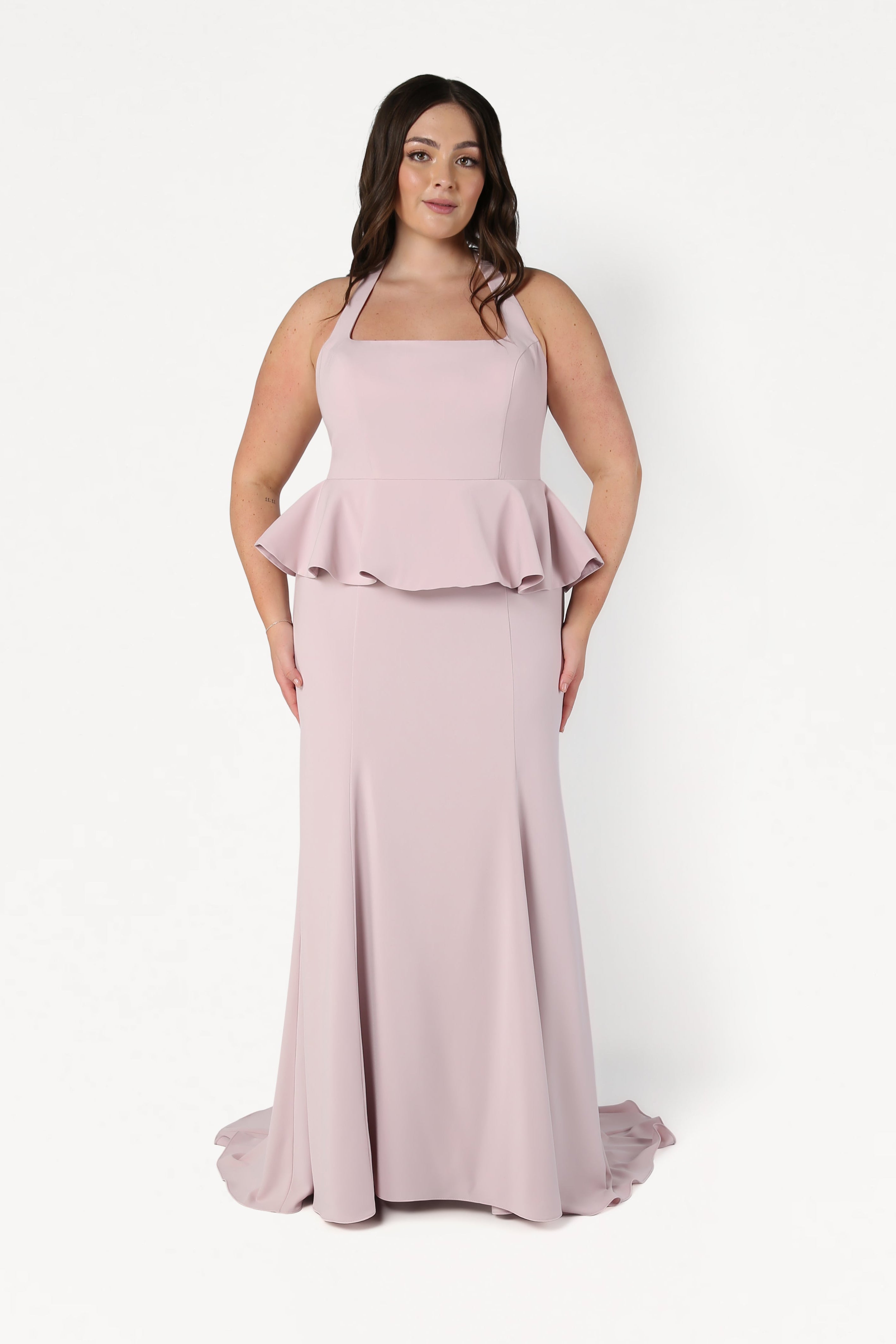Woman wearing a pink evening gown with a white background