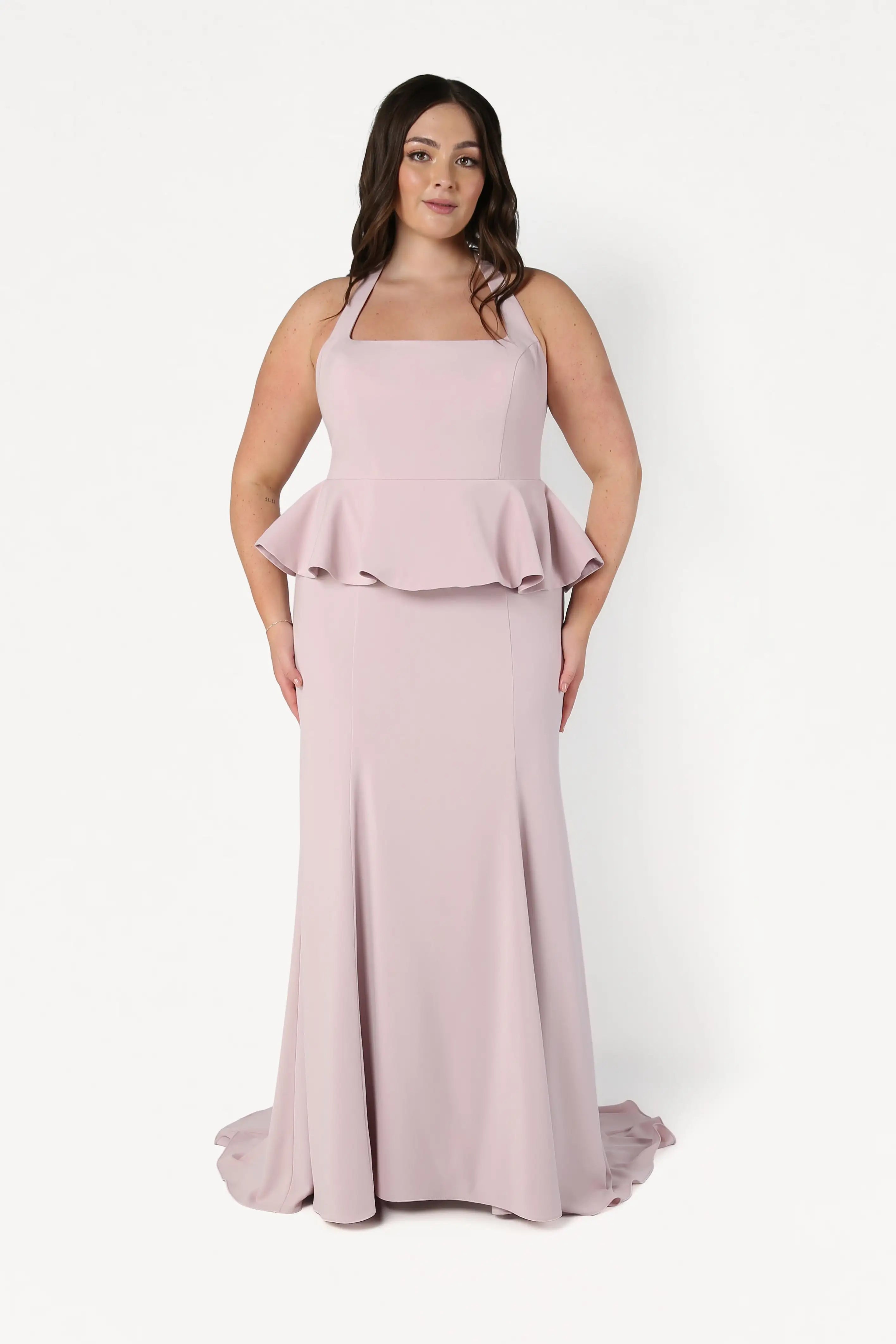 Woman wearing a pink evening gown with a white background