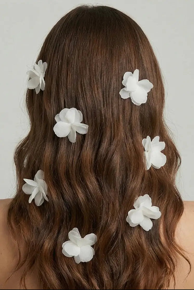 A person with long, wavy brown hair, seen from behind, wears several TH&TH Petal Hair Pins 3pcs evenly spaced throughout their hair against a plain light background.