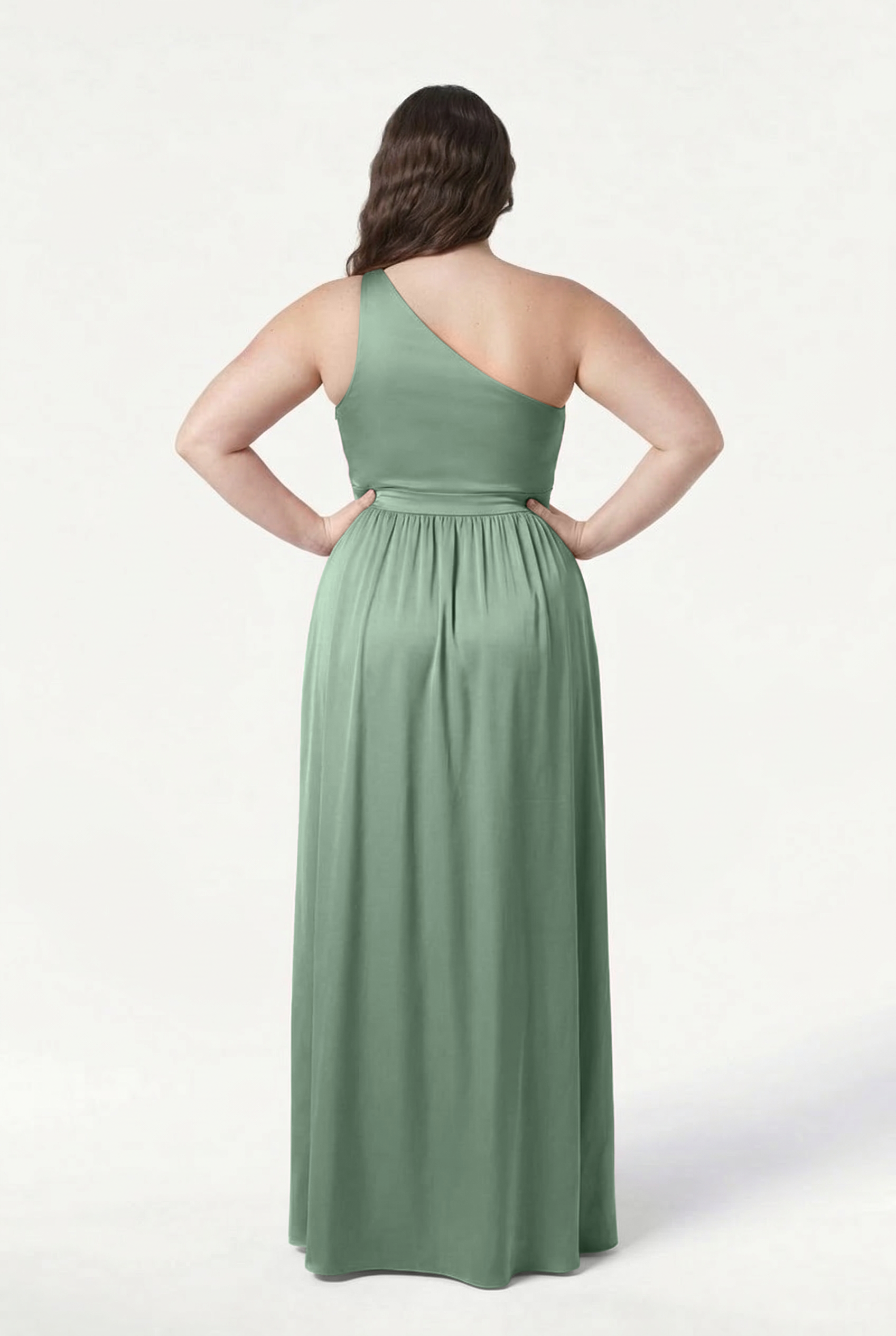 Back view of a woman wearing the TH&TH Greta Bridesmaid Dress in sage green satin, featuring a one-shoulder design, Grecian draping, gathered skirt, and open back, set against a white background.