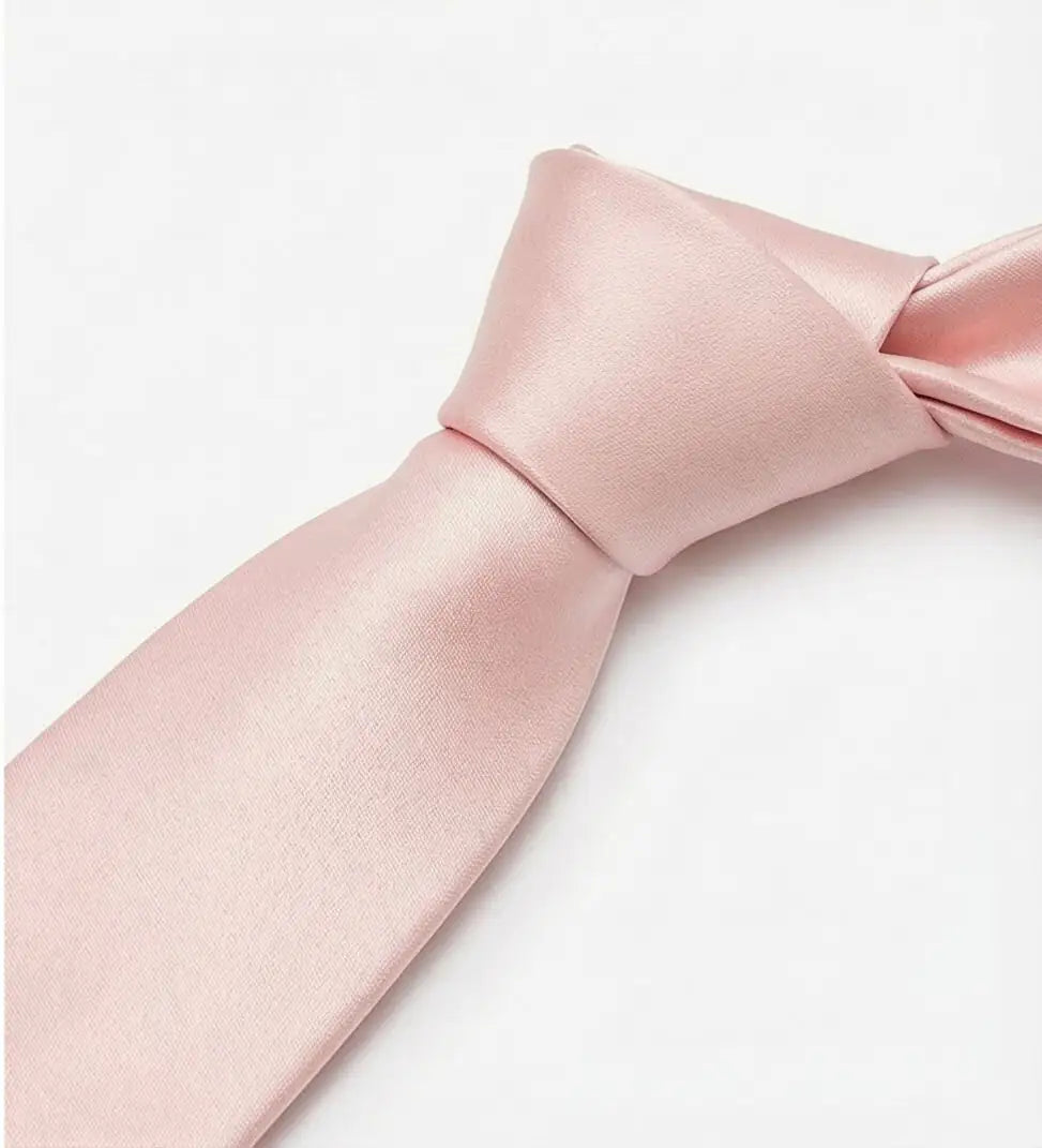 A close-up of a neatly tied, light pink TH&TH Satin Tie on a plain white background, ideal for complementing wedding party or bridesmaid attire.