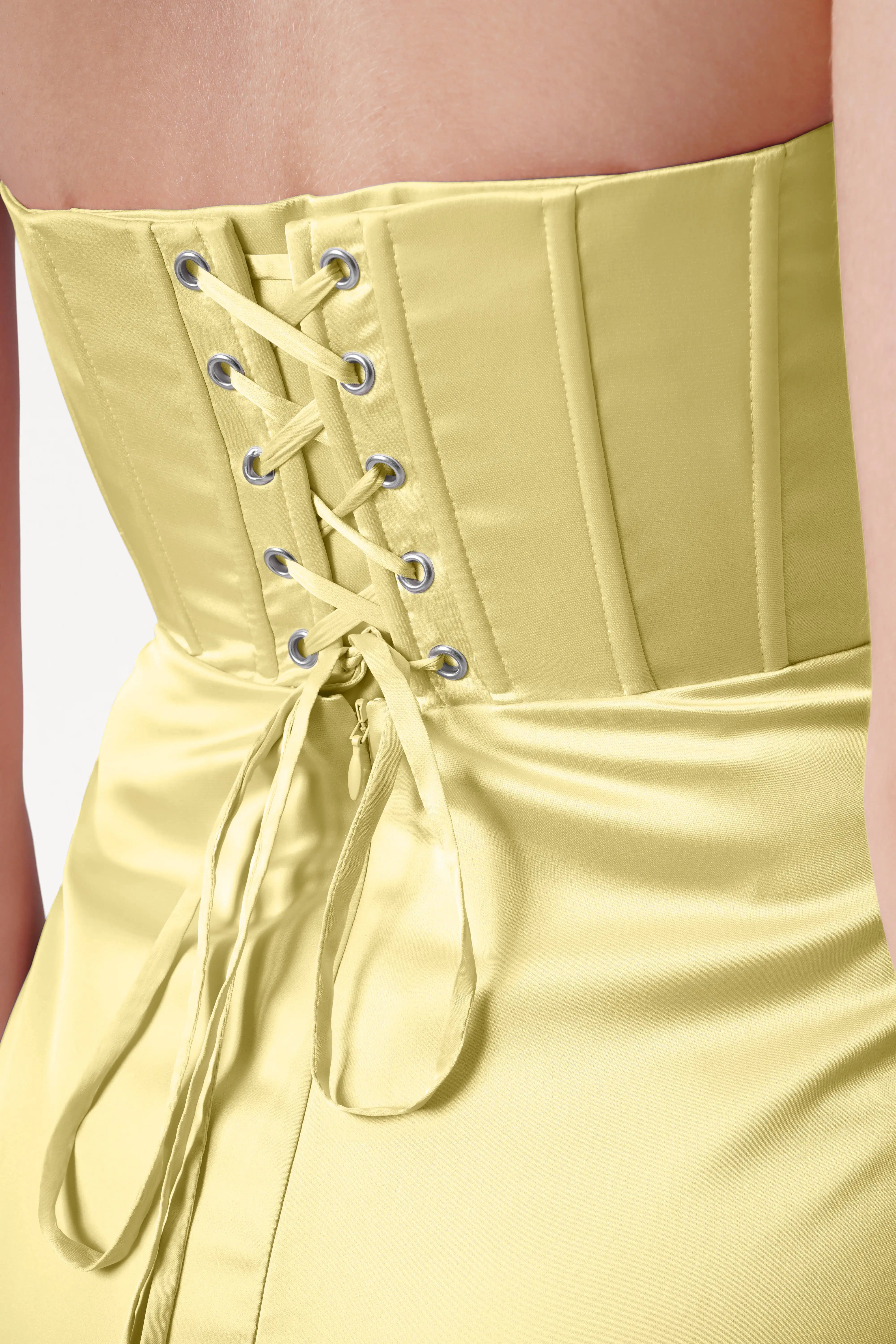 Close-up of the Selena Bridesmaid Dress in Limoncello Satin by TH&TH, featuring a corset-style lace-up back with metal eyelets and ribbon ties, showcasing its size-inclusive fit.
