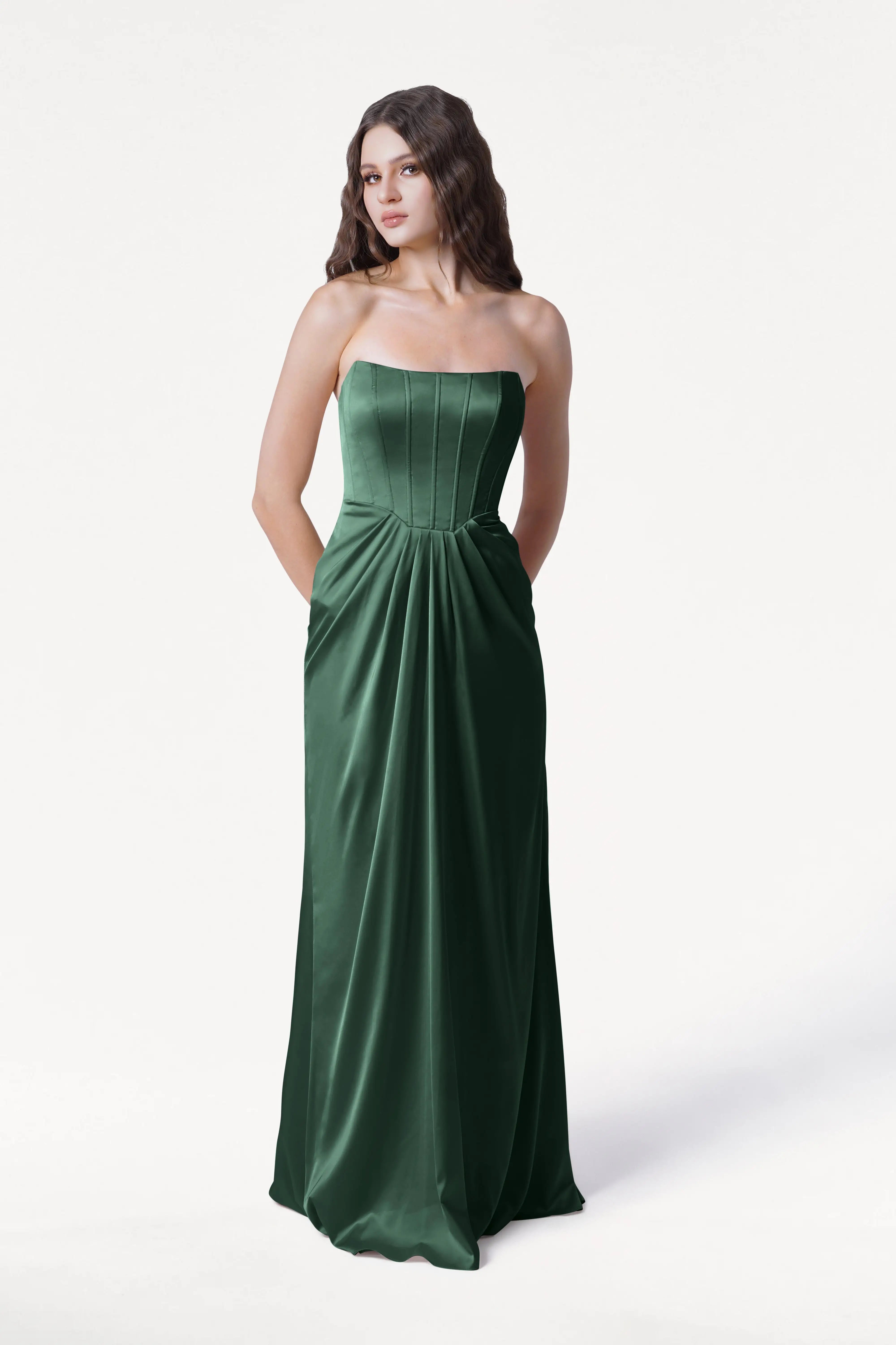 Woman wearing a strapless green gown on a white background