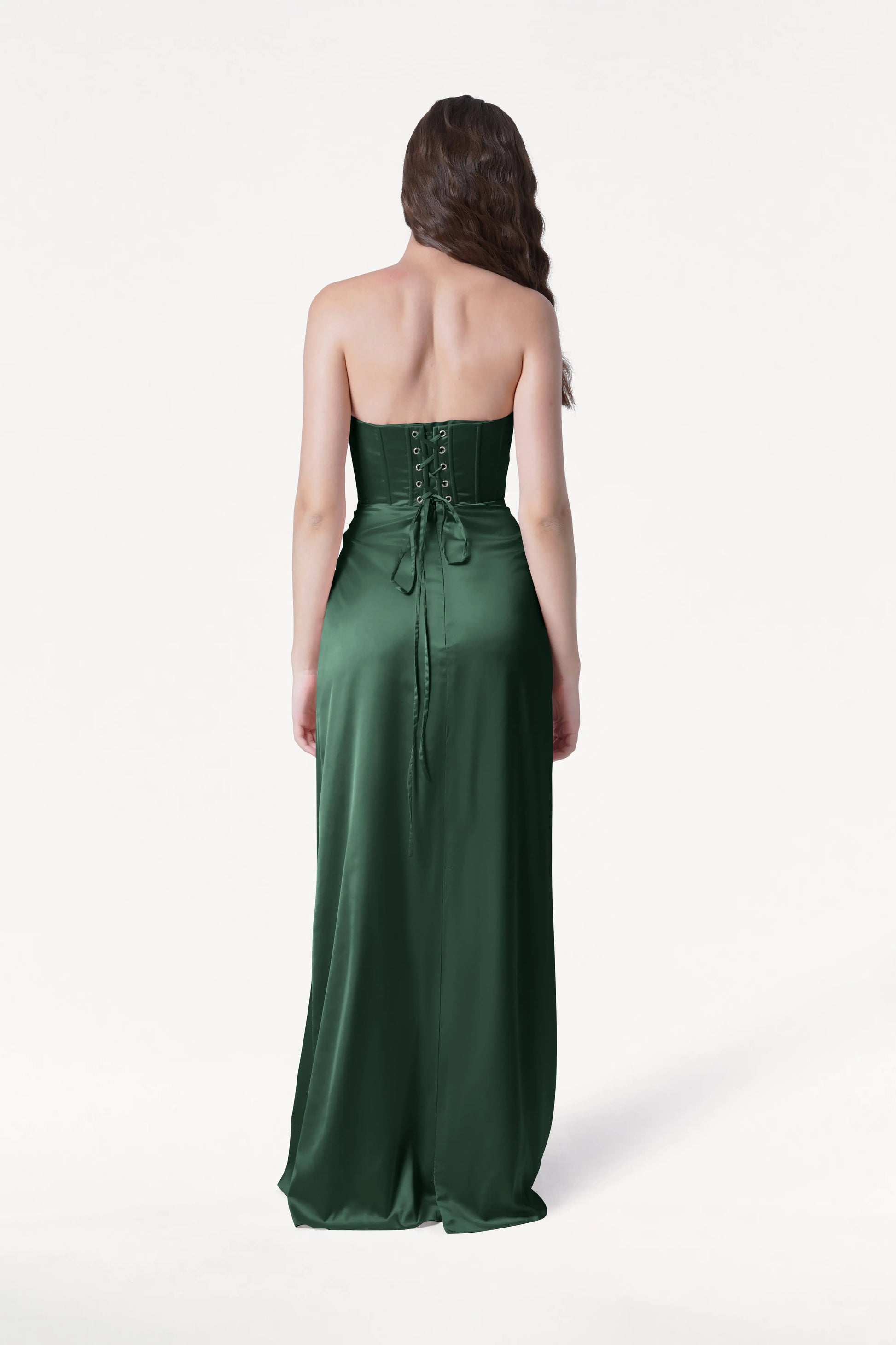 Woman wearing a green strapless gown on a white background