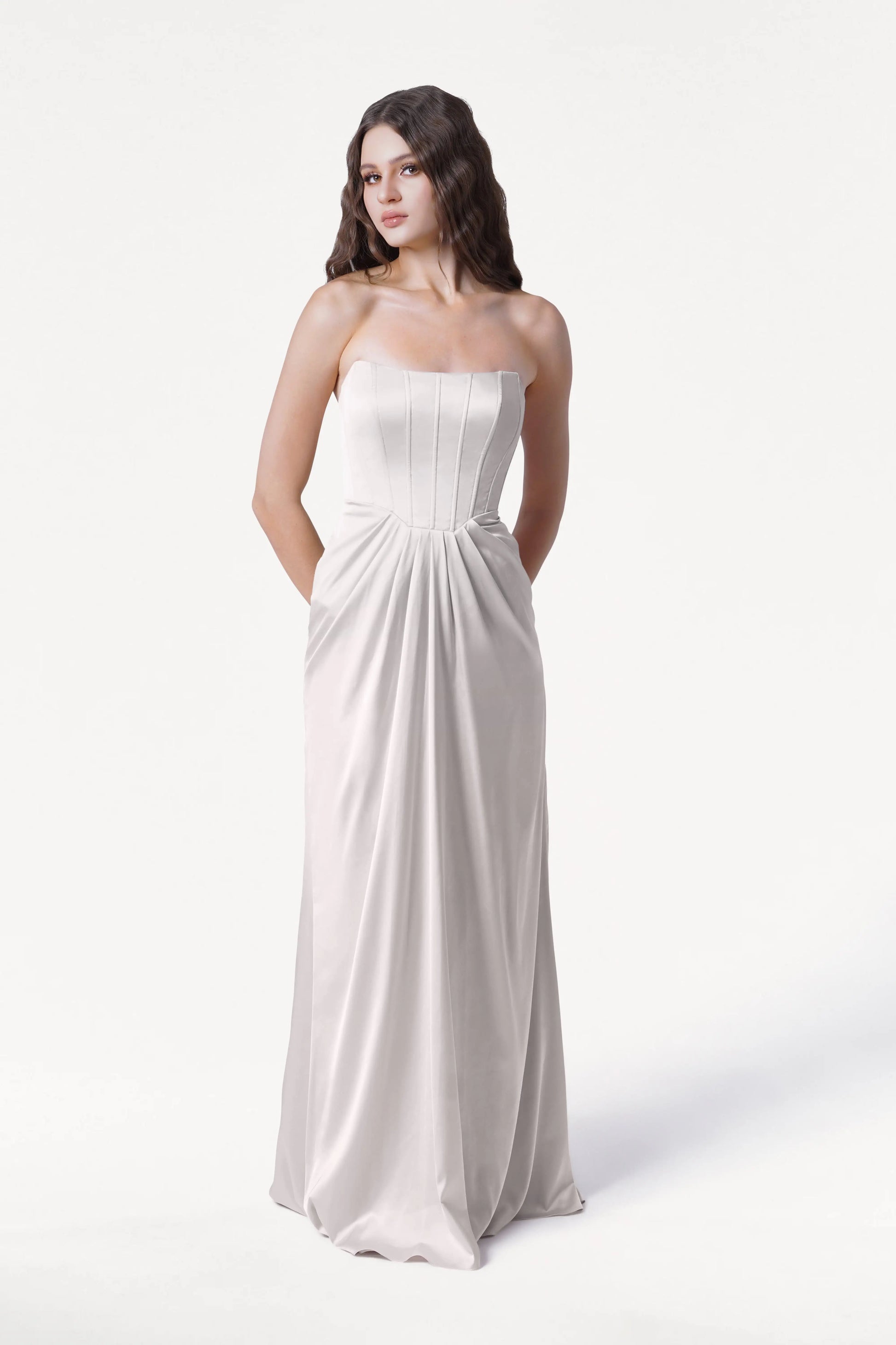 Woman wearing a strapless white gown on a white background