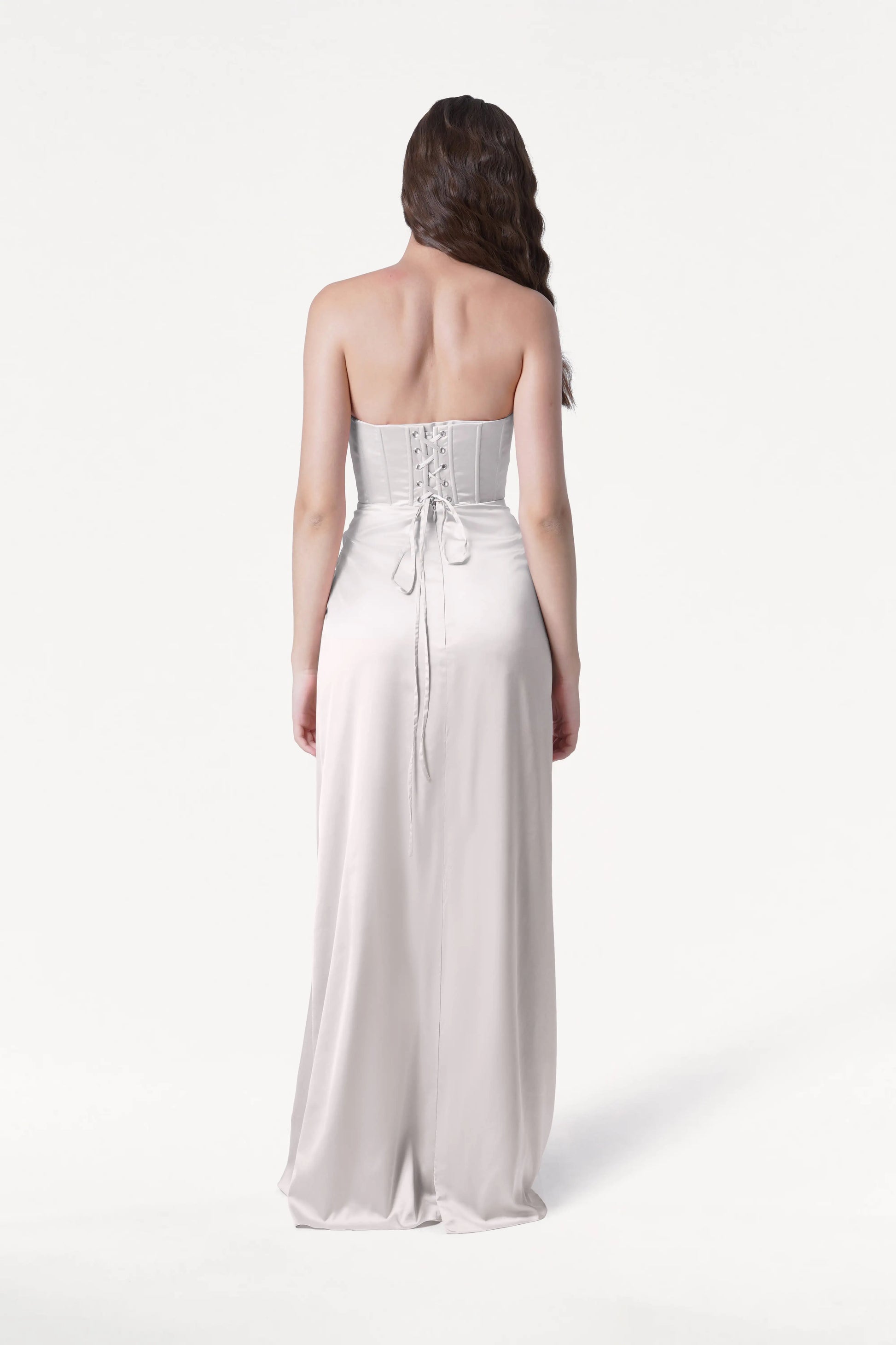 Woman wearing a strapless white gown on a white background