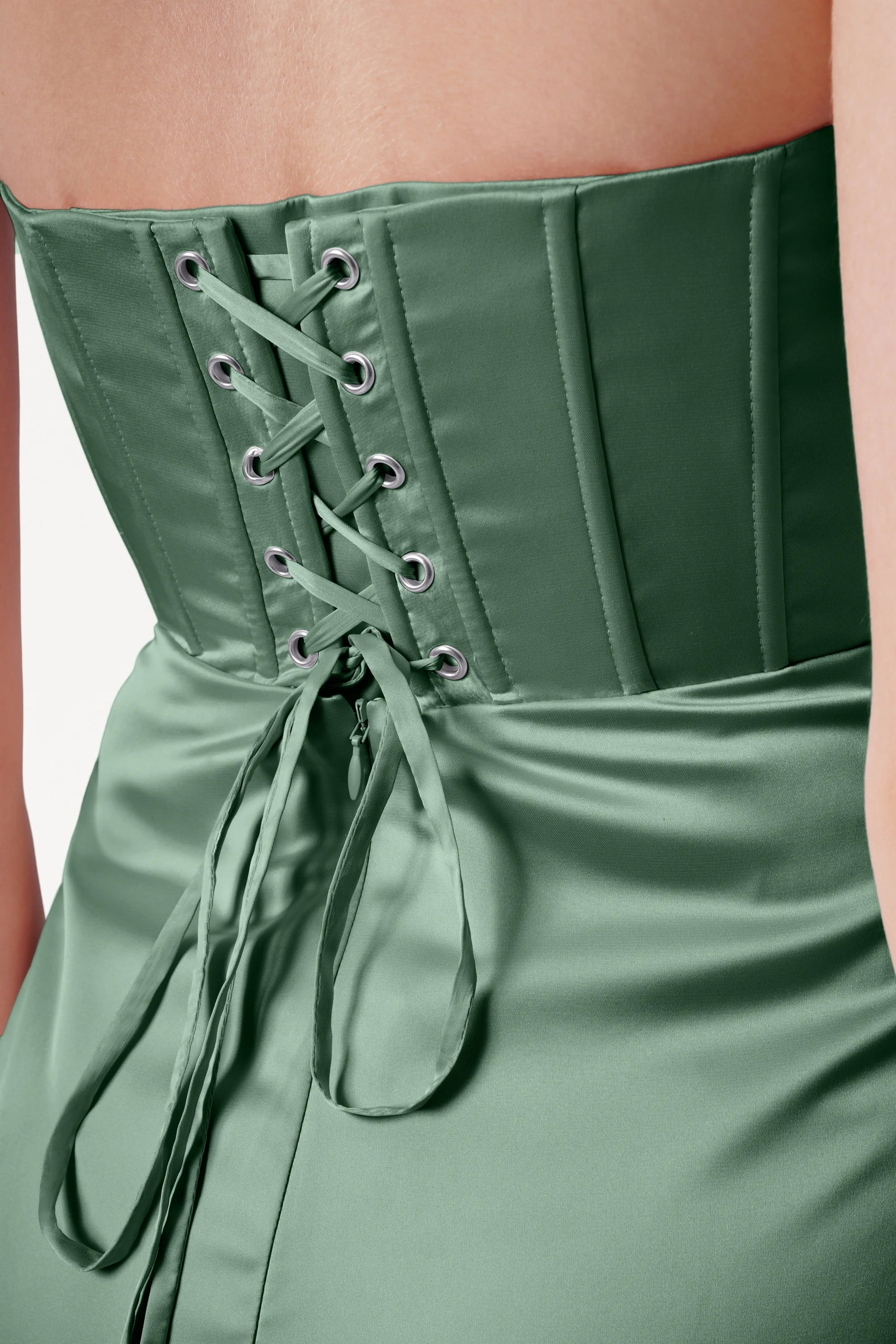 Green corset-style dress with lace-up back on a plain background