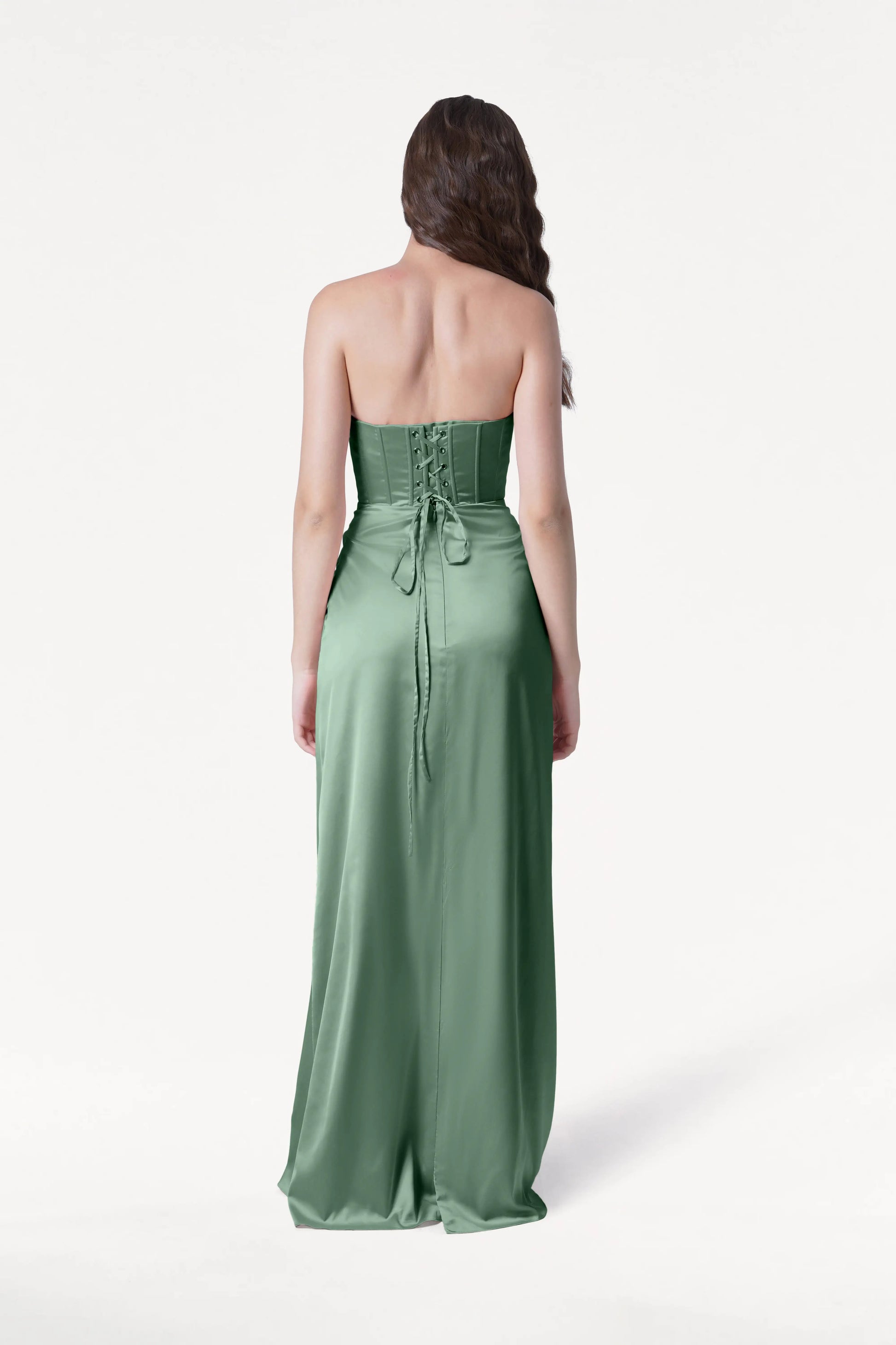 Woman wearing a green strapless gown on a white background