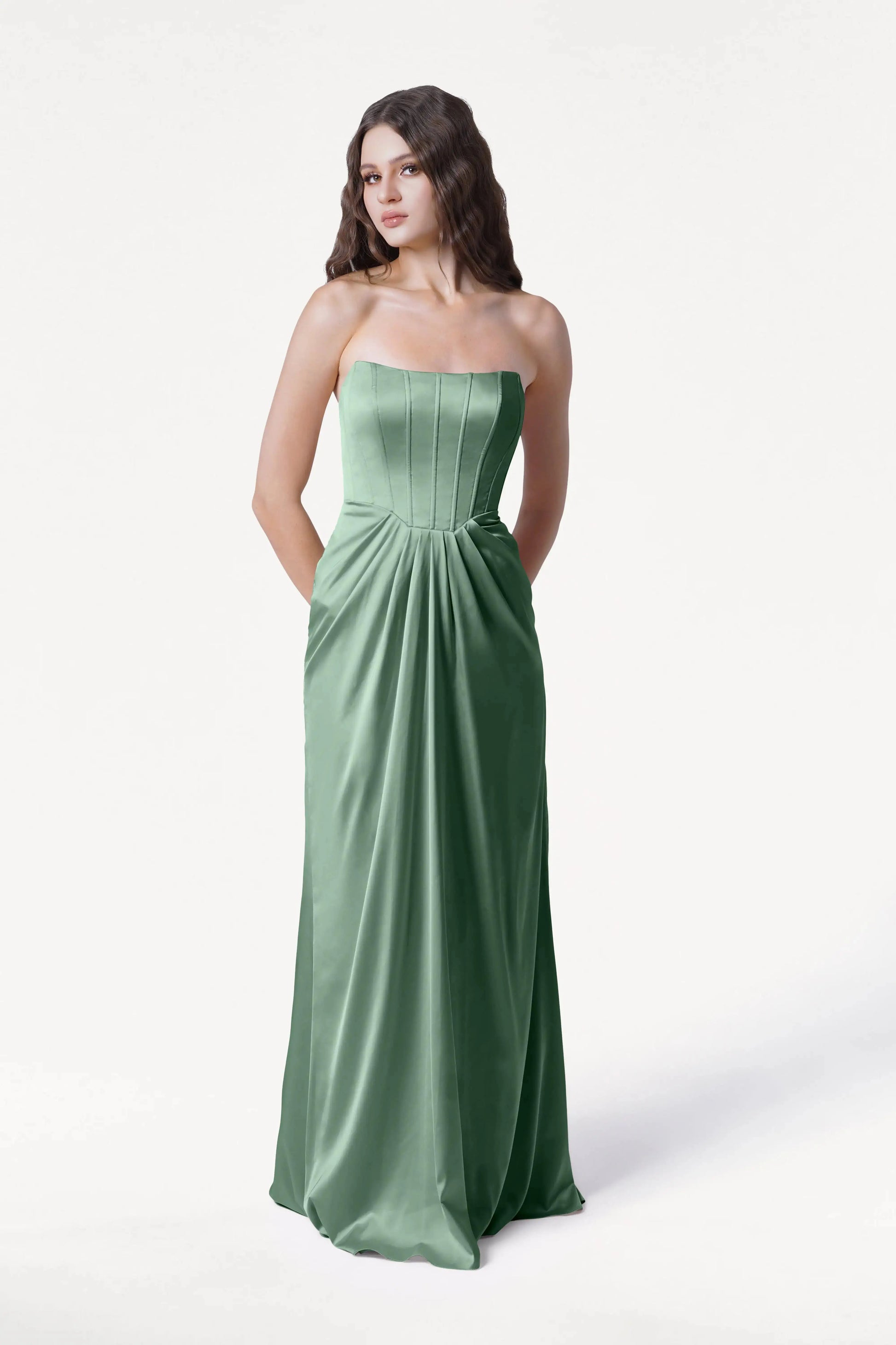Woman wearing a strapless green gown on a white background