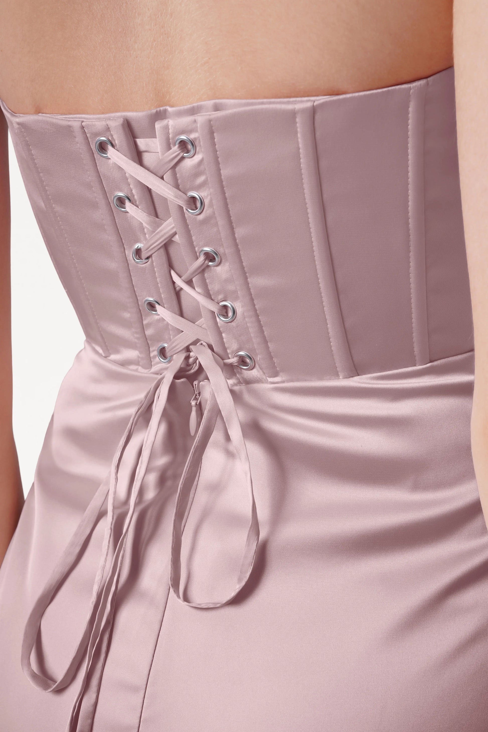 Close-up of the Selena Bridesmaid Dress in Smoked Blush Satin by TH&TH, featuring a size-inclusive fit, corset-style lace-up back with boning, and ribbons tied into a bow at the waist.