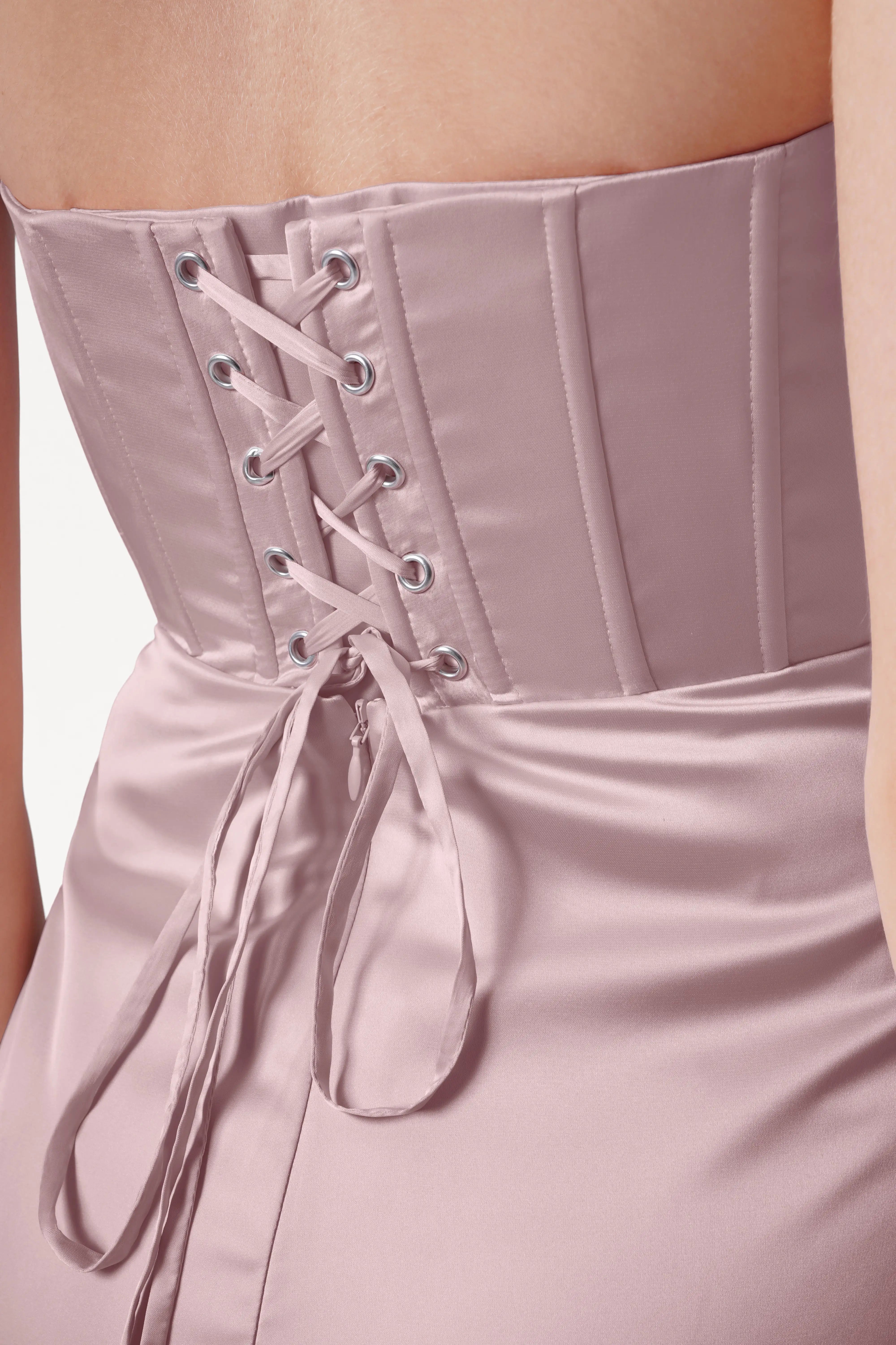 Close-up of the Selena Bridesmaid Dress in Smoked Blush Satin by TH&TH, featuring a size-inclusive fit, corset-style lace-up back with boning, and ribbons tied into a bow at the waist.