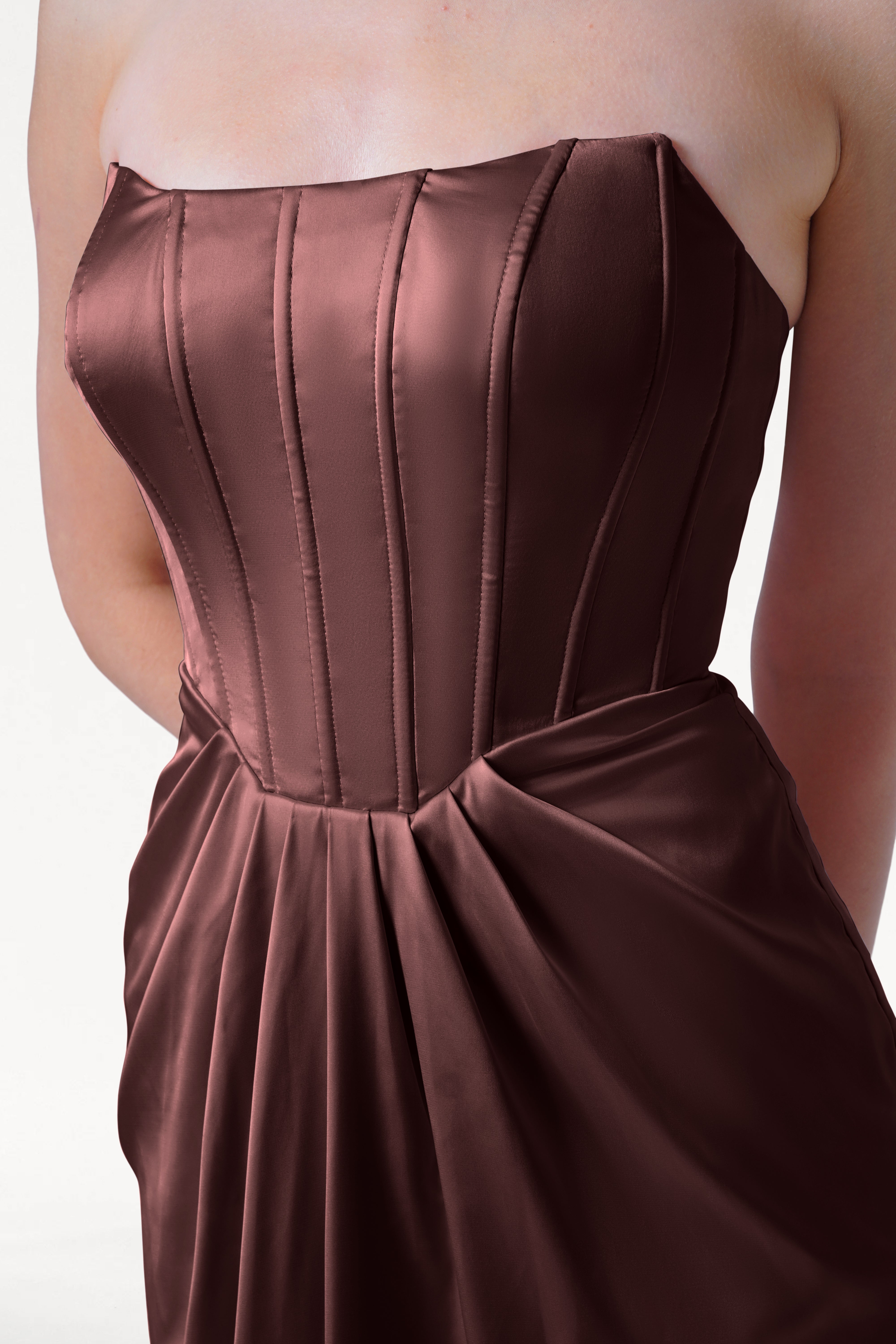 Brown strapless dress with a bow detail on a white background