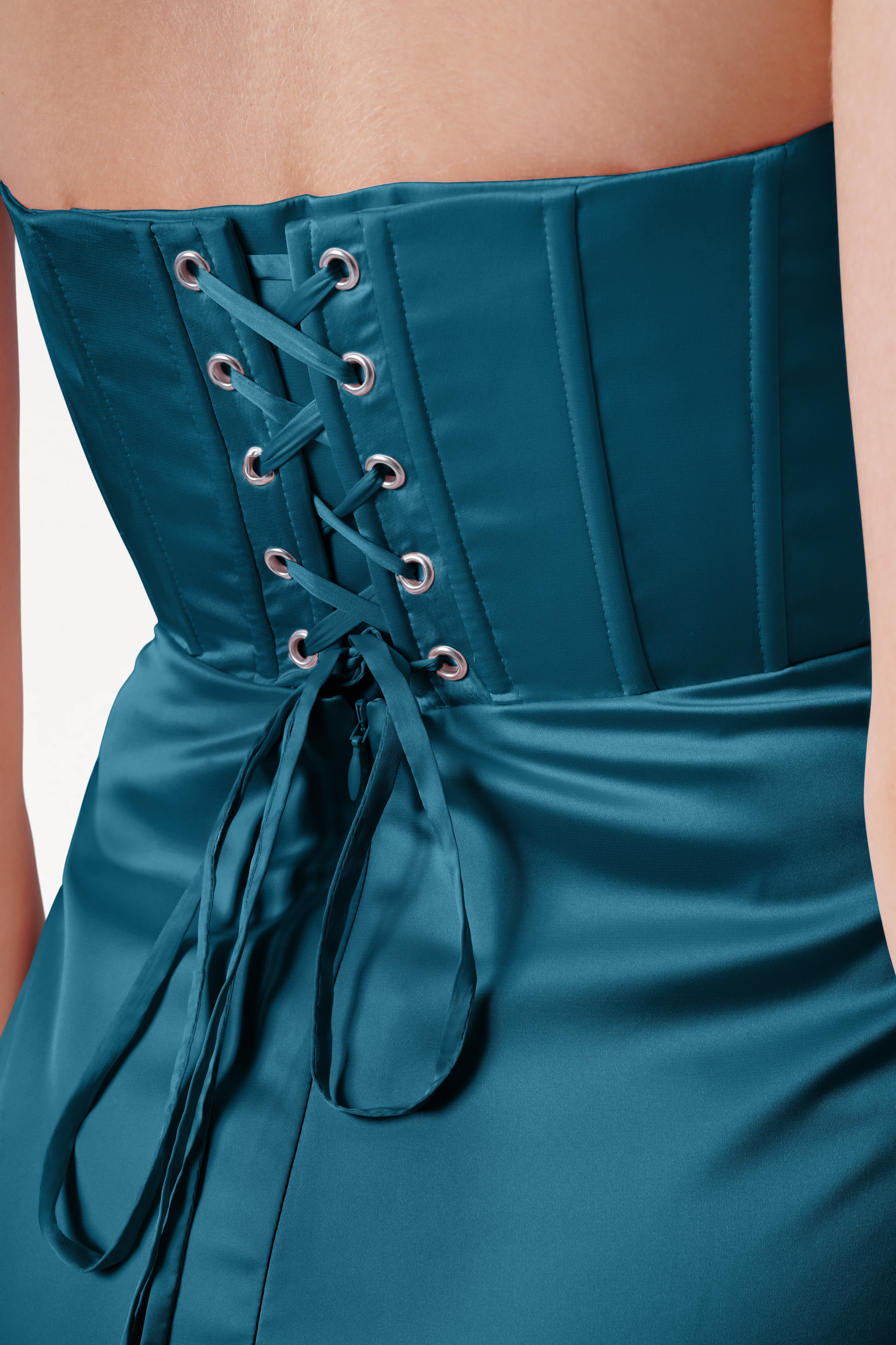 Teal strapless dress with lace-up back on a neutral background