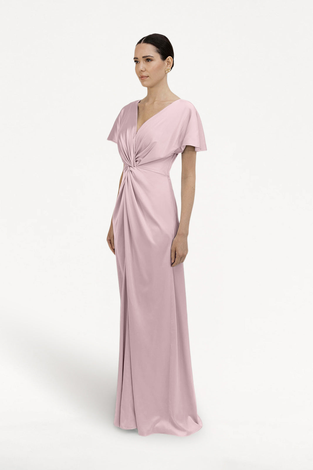 A woman models the TH&TH Camilla Bridesmaid Dress in Smoked Blush Satin, featuring short flutter sleeves and a gathered twist waist, set against a plain white background.