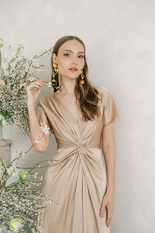 Champagne satin maxi bridesmaid dress with twist knit front detail and sleeves.