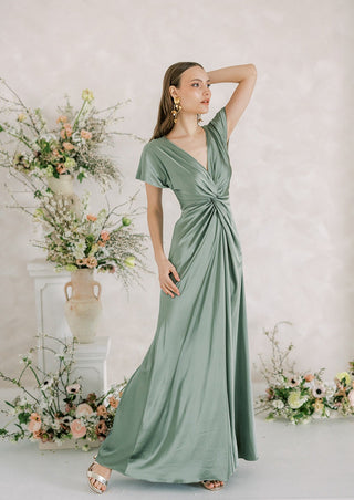 Sage green satin maxi bridesmaid dress with twist knot front detail.