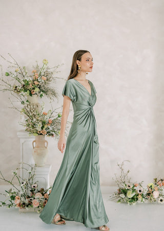 Sage green satin maxi bridesmaids dress with twist knot front detail.