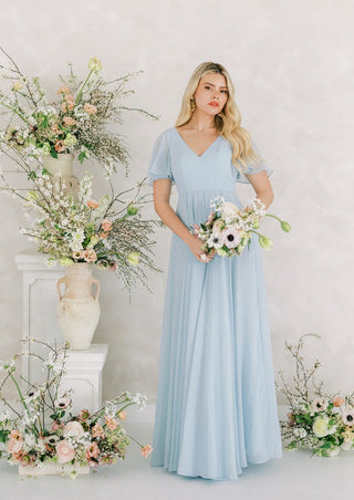 Dusty blue chiffon bridesmaids dress with flutter sleeves.
