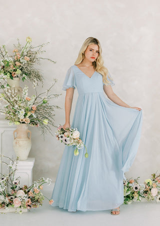 Dusty blue chiffon bridesmaids dress with flutter sleeves.