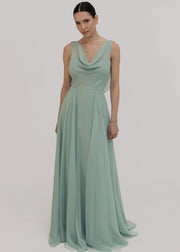 Model wearing green bridesmaid dress front view with a white background by TH&TH.
