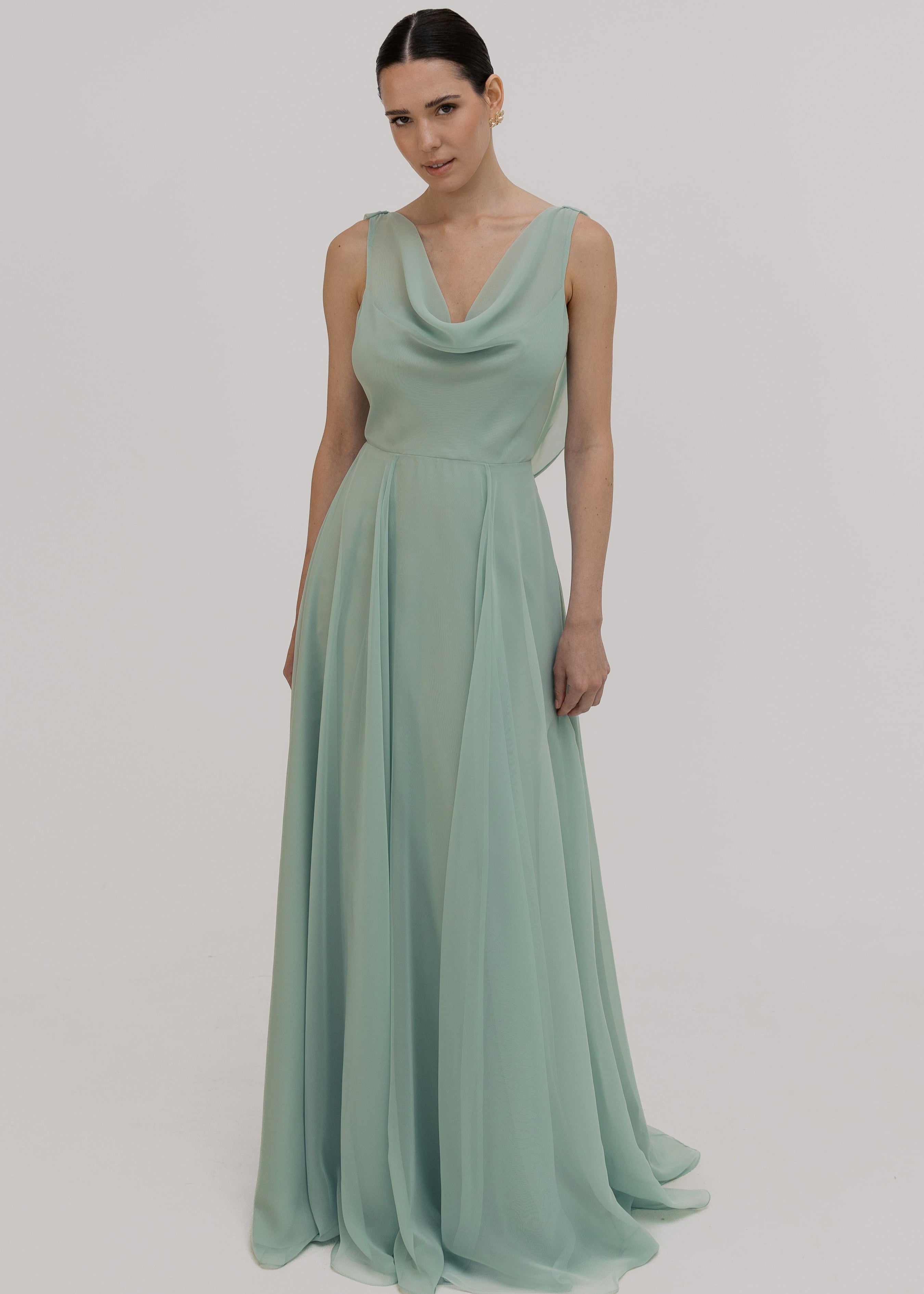 Model wearing green bridesmaid dress front view with a white background by TH&TH.