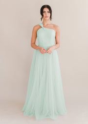 Woman model wearing green bridesmaid dress in tulle fabric by TH&TH Bridesmaids.
